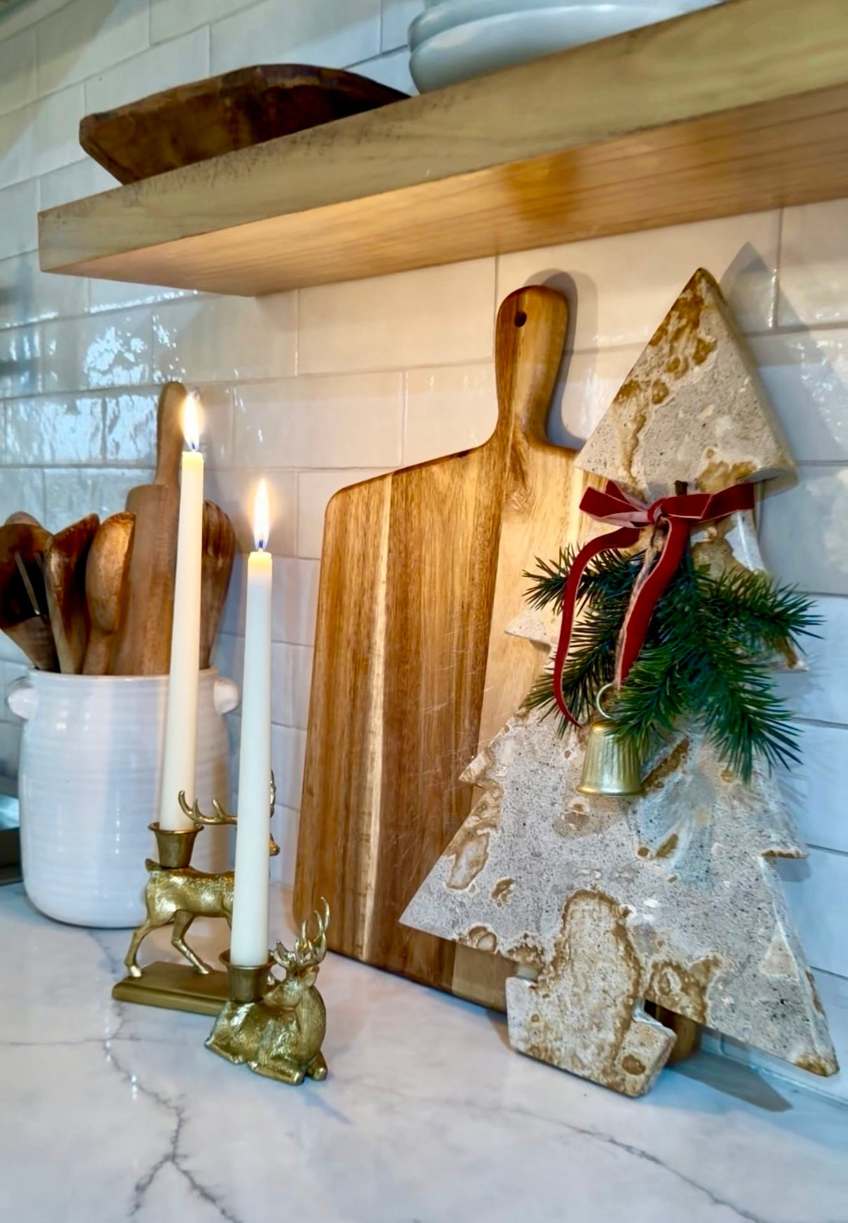 Holiday Kitchen Vignette 🌲 Love adding a marble cheese platter with a holiday swag to my kitchen during the holidays. 

🏷️ holiday decor , kitchen decor , cheese board , gifts under $50 , charcuterie board , holiday candle , candle holders , kitchen shelves , kitchen tile , open shelves , utensils holder

#LTKHome #LTKHoliday #LTKCyberWeek