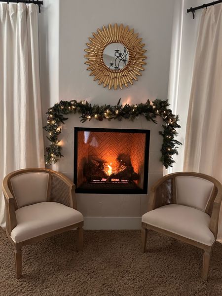 Loving this winter time fireplace with lit garland and cozy barrel chairs 

#LTKHoliday #LTKSeasonal #LTKhome