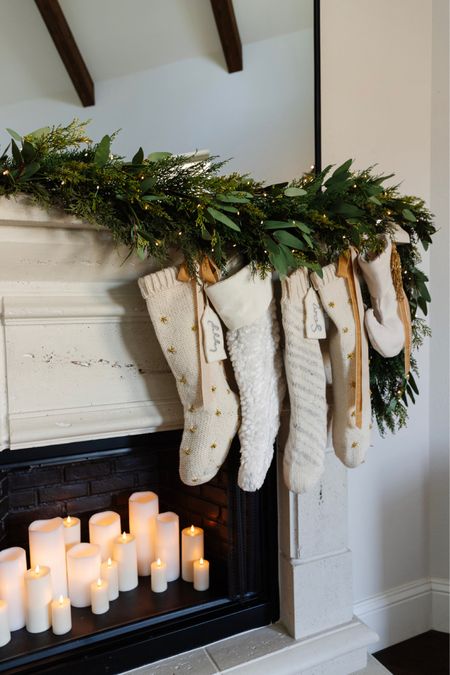 Christmas fireplace mantle decor with garland, neutral stockings, and faux candles 



#LTKSeasonal #LTKHoliday #LTKhome