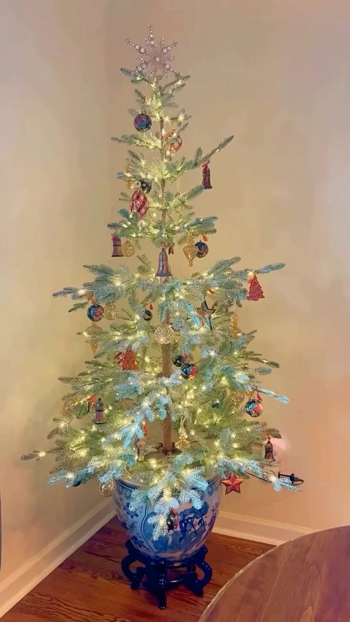 Tree # 2 — in the dining room — is up! This is the tree I usually put my vintage ornaments on.  But since I upgraded that tree, I thought it would be a great size to add some Christmas glow to a corner of the dining room. 💫 The @balsamhill Frosted Alpine Fir is potted up in an Amazon Chinoiserie planter.  Almost all the ornaments are from my time living in India for two years after college — some Kashmiri papier-mâché and some blown glass from a trip to Egypt.  I added some gold mercury glass to fill it up a little more!

💬So…do you decorate more than one tree in your home? Let me know in the comments!
•
•
•
•
•
•
Vintage Home Style | Vintage Decor | Vintage Holiday Decor | Eclectic Style | Maximalist Home | Colorful Home | Home Inspiration | Holiday Styling | Collected Home | Traditional Home | Vintage Christmas | Curated Home

#christmasdecorinspo #christmastreeinspo #holidayhomedecor #vintagechristmas #herbeautifulhaven #curatingajoyfullife