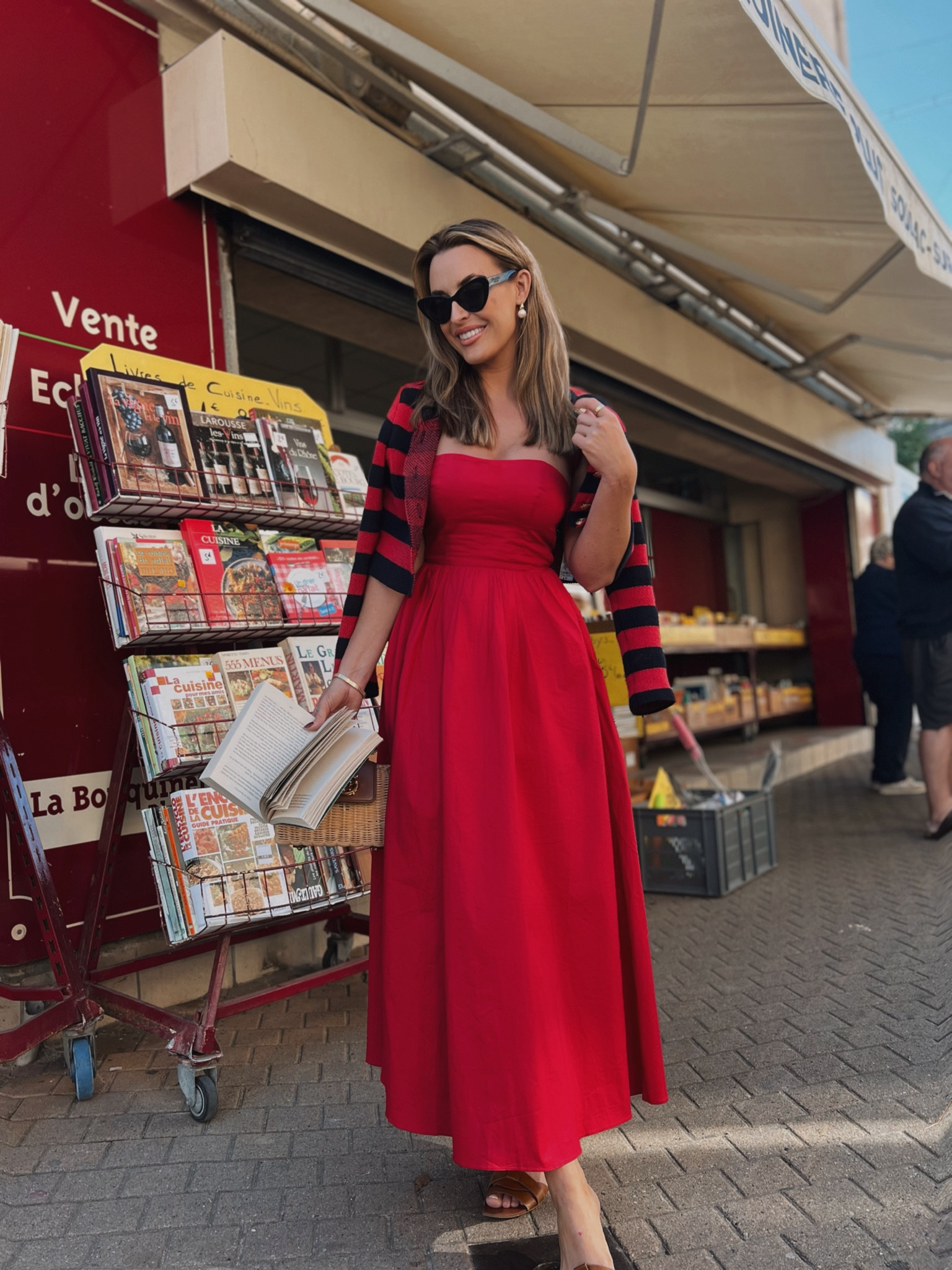 Lady in red on the streets of Soulac sur Mer ⚓️🇫🇷 Bandeau red dress with striped cardigan and tan flats for a day of exploring 

#LTKtravel #LTKstyletip #LTKmodest