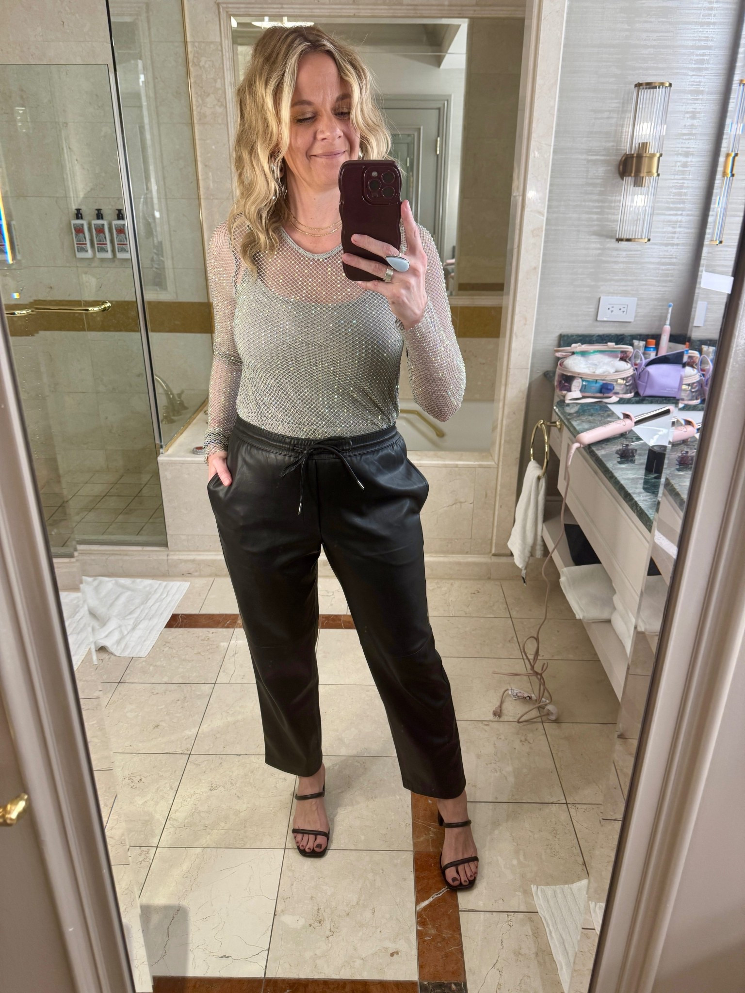 My Vegas Night 1 Look 🌟

Night one in Vegas was packed—dinner reservations, a show, and drinks at a speakeasy bar. I wanted to lean into the Vegas energy and take my usual elevated casual style up a notch. When in Vegas, right?

This sheer mesh top from Nuuly was perfect for that. It had just the right amount of sparkle and edge without feeling costumey. I paired it with faux leather joggers I already owned and black block heel sandals. The joggers kept me comfortable through a long night of walking and sitting, while the heels and statement top made it feel special.

#LTKdayinmylife #LTKootd #LTKgrwm