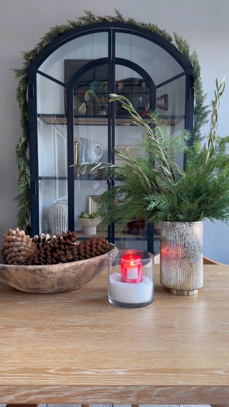 The finishing touches to the house before the holidays. Adding snow to a glass vase with a pretty candle sets the mood for a holiday gathering. My arched cabinet and table are linked along with the voluspa candle, similar wood bowl and a similar Mercury vase. 

#LTKHoliday #LTKstyletip #LTKhome
