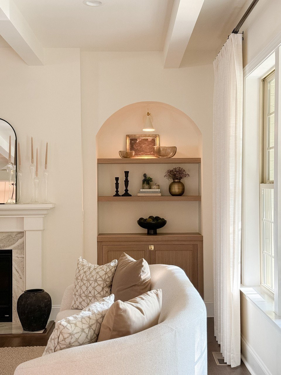 Living Room. Upholstered Sofa, Moss Bolls, Liz Linan Drape Pleated, Ceiling Light, Brass Wire Decorative Bowl, 1 Light Wall Sconce, Cogan Armed Sconce, Area Rug, Moody Trees Framed Wall Canvas Board. 

#LTKHome