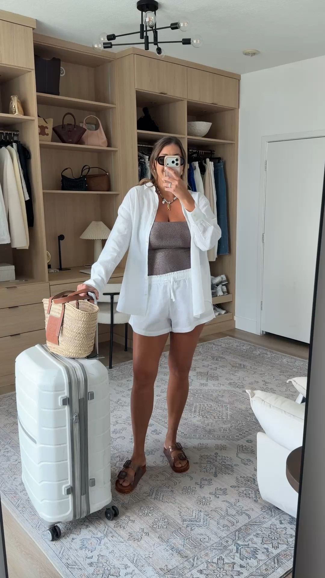 Packed light, styled right. 🤍 This easy travel look is made for airport days and coastal getaways with breathable linen layers, comfy sandals, and a woven tote that goes with everything.

travel outfit, airport outfit, vacation outfit, coastal style, white linen set, linen shorts, oversized button down, tube top, woven tote, raffia bag, brown sandals, summer outfit, resort wear, beach vacation, travel style, neutral outfit

#LTKTravel #LTKMidsize #LTKootd