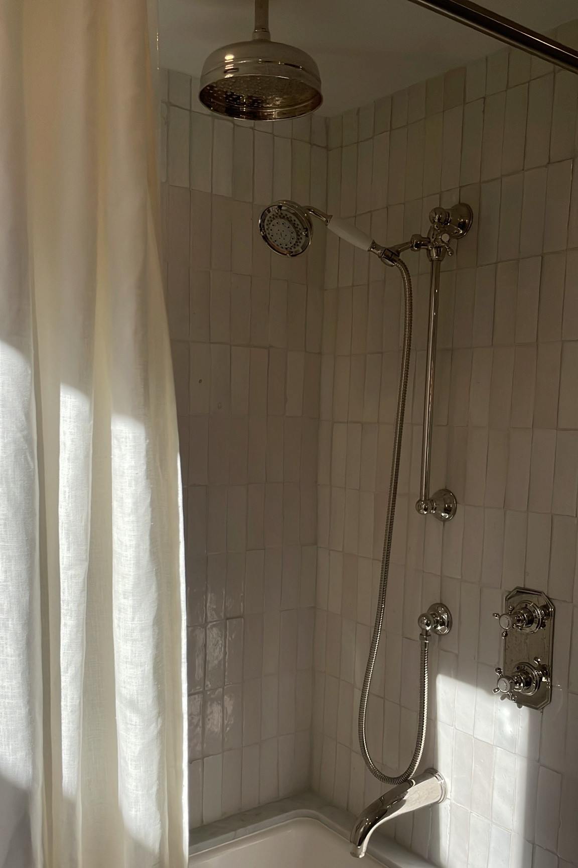 My shower fixtures are polished nickel. I chose a stacked brick install for my tile and the grout colour is Mapei Frost. 

#LTKhome