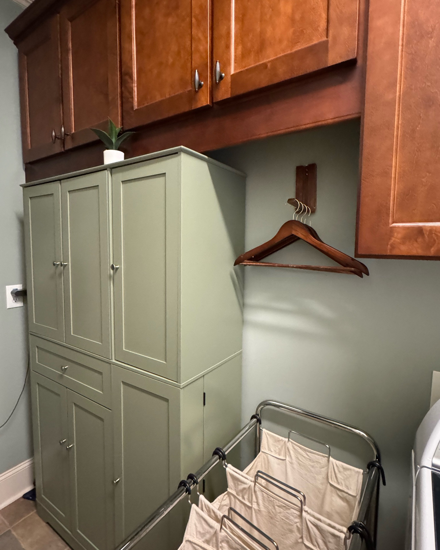 Mike and I (mostly Mike) just put together this much needed storage unit for our laundry room. I absolutely love the sage green color! It matches perfectly! Shelves, drawers, storage in the drawer keeps everything hidden and organized.

#LTKmomlife #LTKHome #LTKstorytime