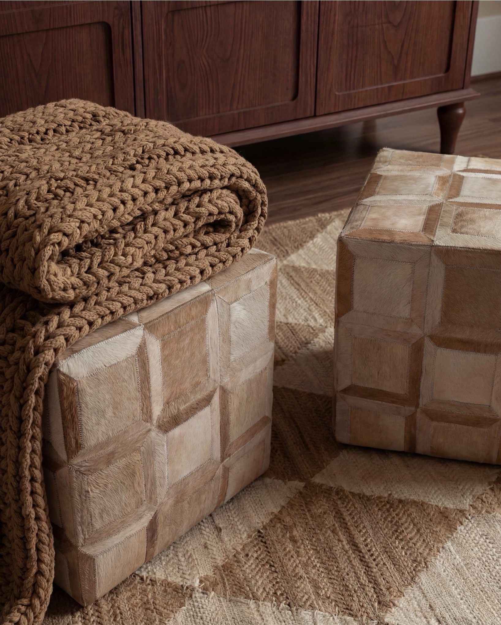 Shop the Look:
• Wood console table
• Framed landscape wall art (black frame)
• Neutral ceramic table lamp
• Stone or ceramic decorative bowl
• Large ceramic vase with faux olive branches
• Textured cube stools (neutral tone)
• Chunky knit throw blanket
• Neutral checkered patterned area rug
• White flitted decor bowl
• Brass oval serving tray
• Brown decor books

#LTKsale #LTKhome #LTKstyletip