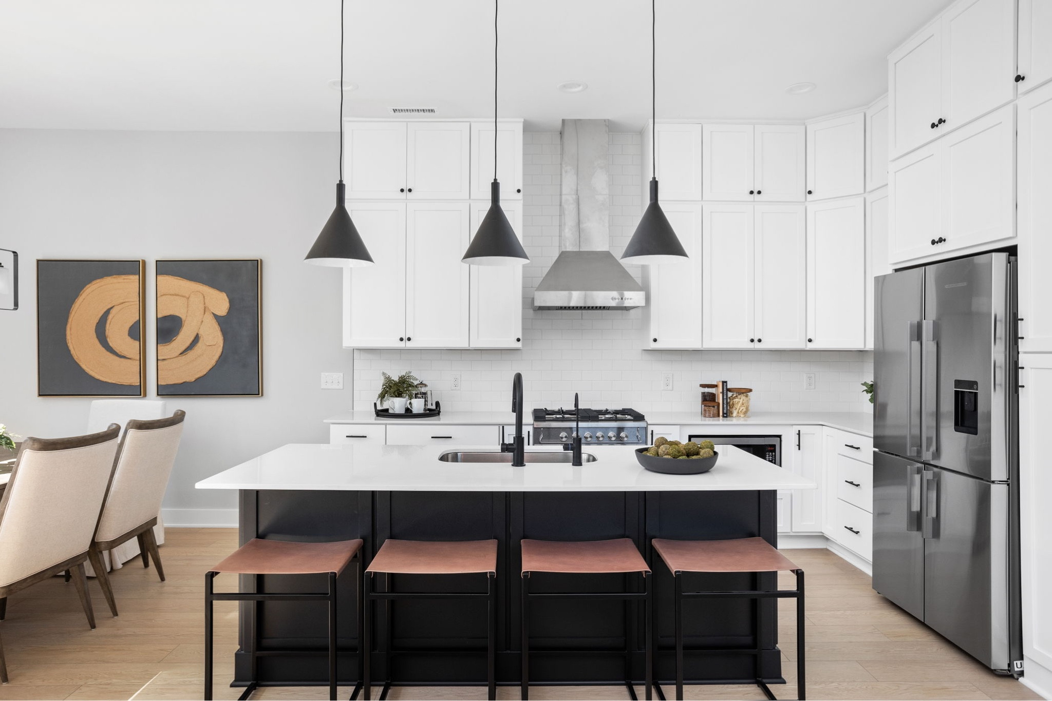 A beautiful white kitchen. We styled the kitchen with natural tones- leather stools, greenery, canisters with wood lids.

Styled: Nested Spaces 
Built: Estridge Homes
Photography: The Home Aesthetic

#LTKstyletip #LTKfamily #LTKhome