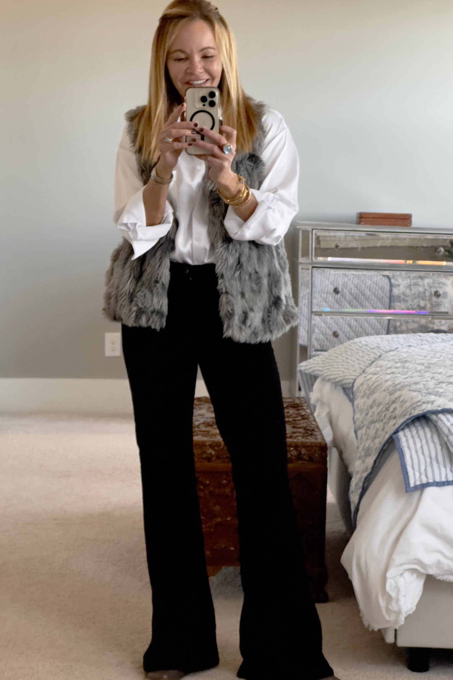 Mob wife trend. Faux fur vest, white oversized button down, velvet wide leg jeans. 

#LTKfindsunder100 #LTKsalealert #LTKstyletip