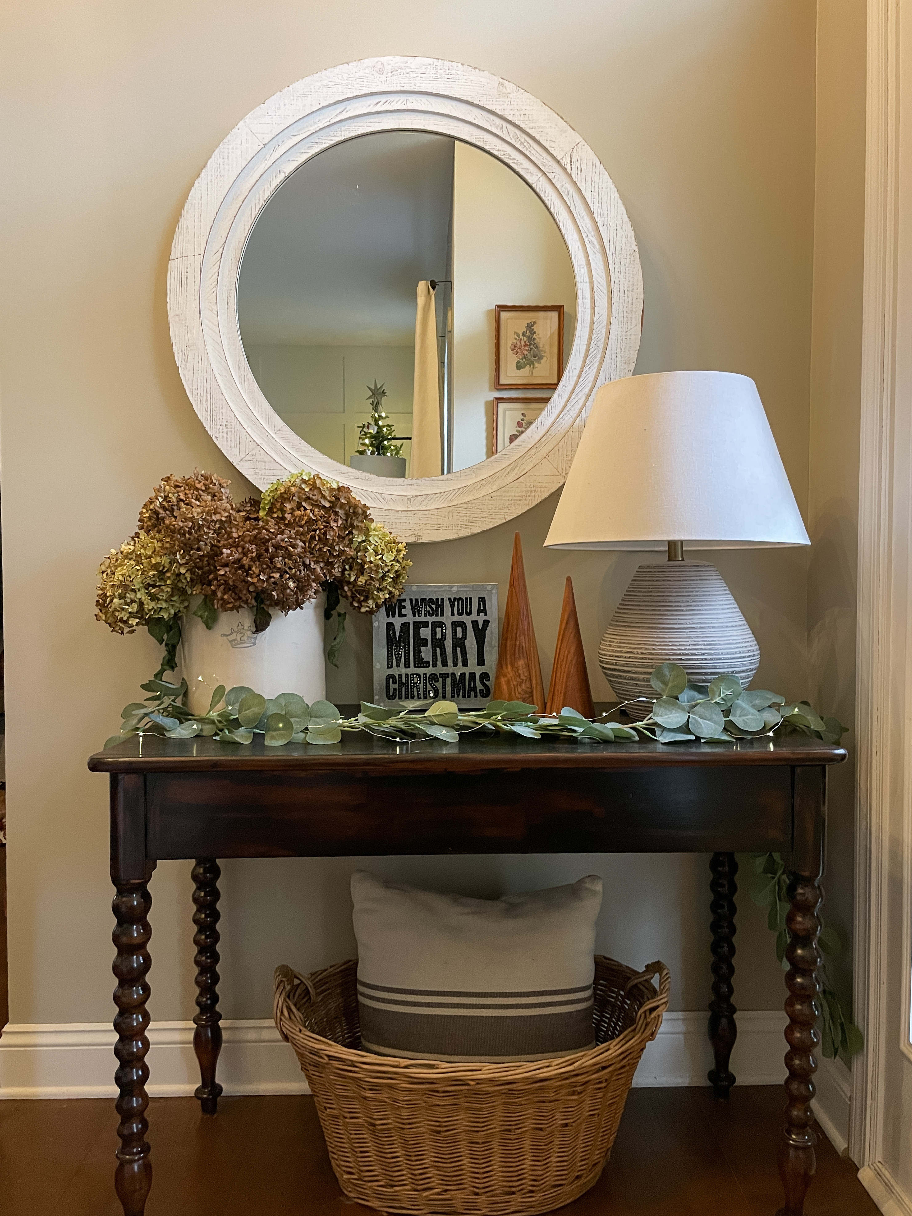 Cozy organic entryway decorated for Christmas.  

Entryway table.  Table lamp Threshold.  White mirror.  Modern wooden Christmas tree.  Eucalyptus garland.  

#LTKHome #LTKHoliday #LTKSeasonal