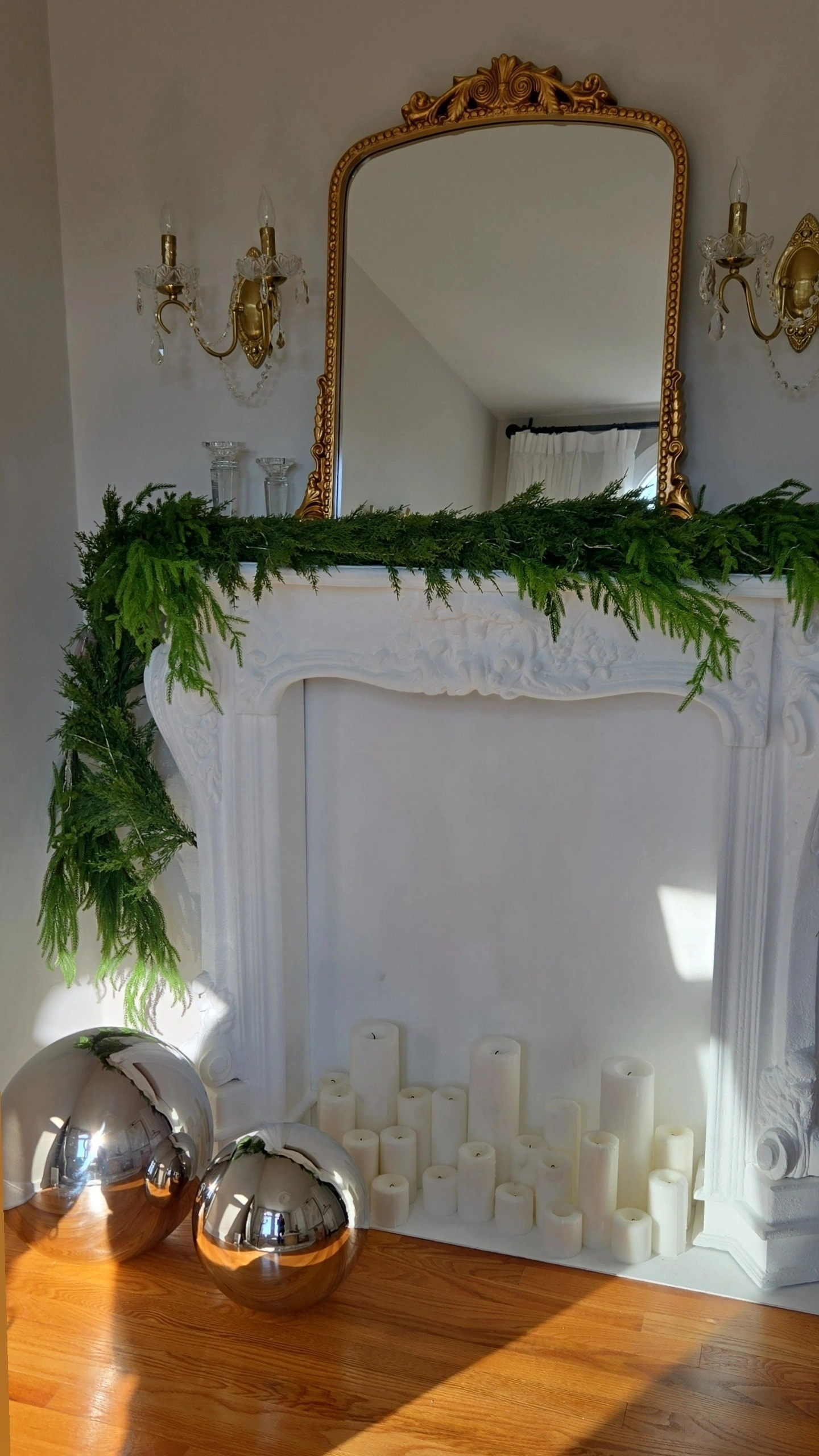 My fireplace is from Ashley Furniture I painted it white with chalk paint. I had Home Depot cut down Plywood And I made that the backing and base and painted that white as well. Crystal sconces, Home Depot mirror, antique look, french, Parisian style, bedroom, pillar candles, silver orb decorations, christmas, holiday.

#LTKHoliday #LTKSaleAlert