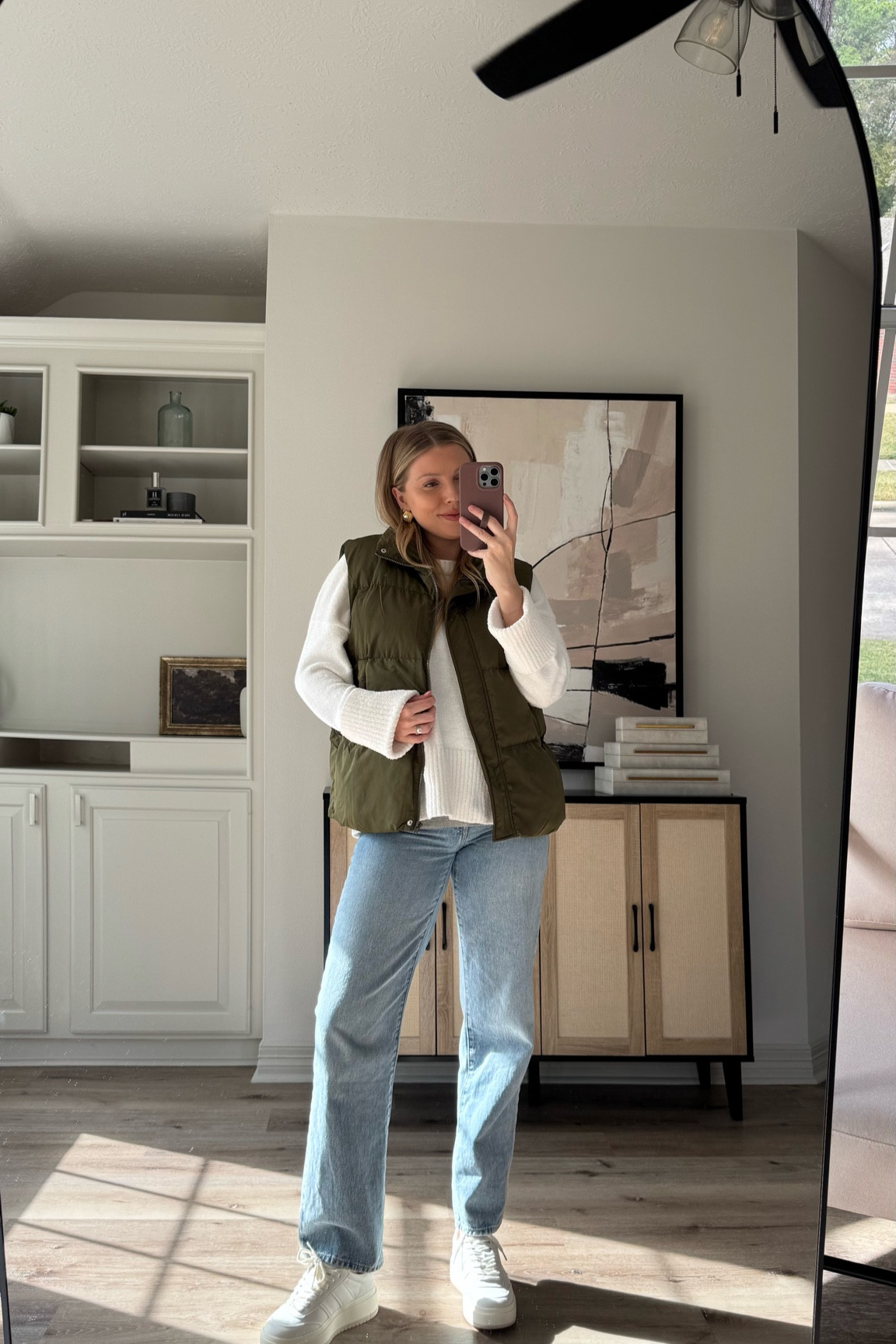 Casual winter outfit | I am wearing the cutest outfit all from Amazon! I love layering pieces like this puffer vest with jeans and sweaters for an elevated casual look. Wearing a S in sweater, L in puffer, 26 in jeans, and sneakers are tts. Wearing a M in belly band to keep wearing my jeans while pregnant! 

#LTKBump #LTKSeasonal #LTKStyleTip