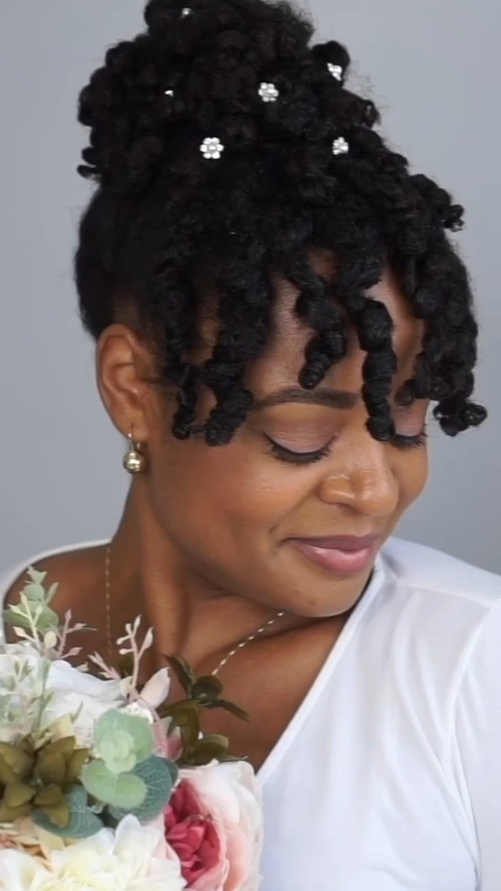 A wedding updo on natural kinky-coily hair. 

#LTKstyletip #LTKbeauty #LTKwedding