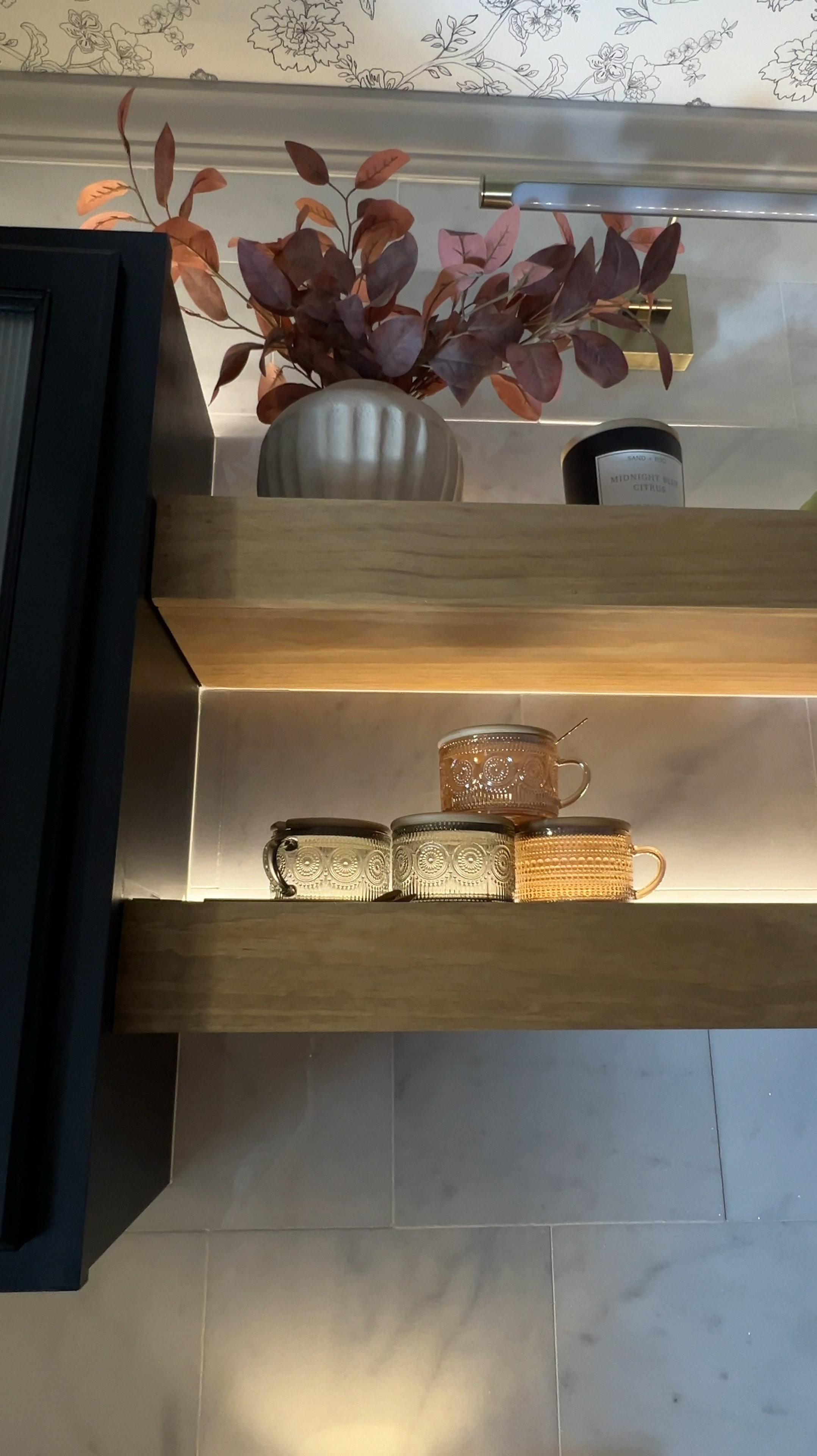 Styling shelves is all about the little details! Loving how these vintage mugs, flowers, vases and candles bring this coffee bar to life.