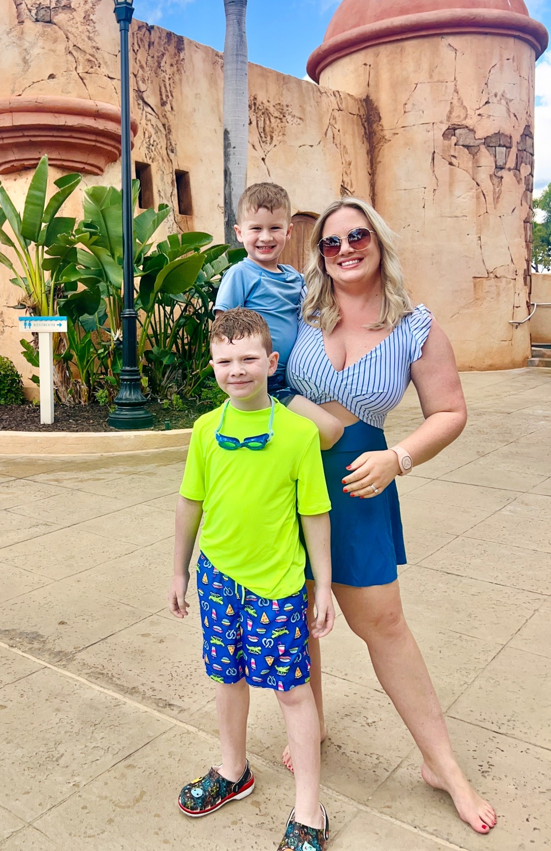 Pool resort swim outfit for midsize mom. Bright swim trunks for boys. Disney resort pool day outfit. Disney mom. Disney kid. Caribbean vacation. Swim dress. Resort outfit. Women's bathing suit for hiding midsection. 

#LTKMidsize #LTKmomlife #LTKKids