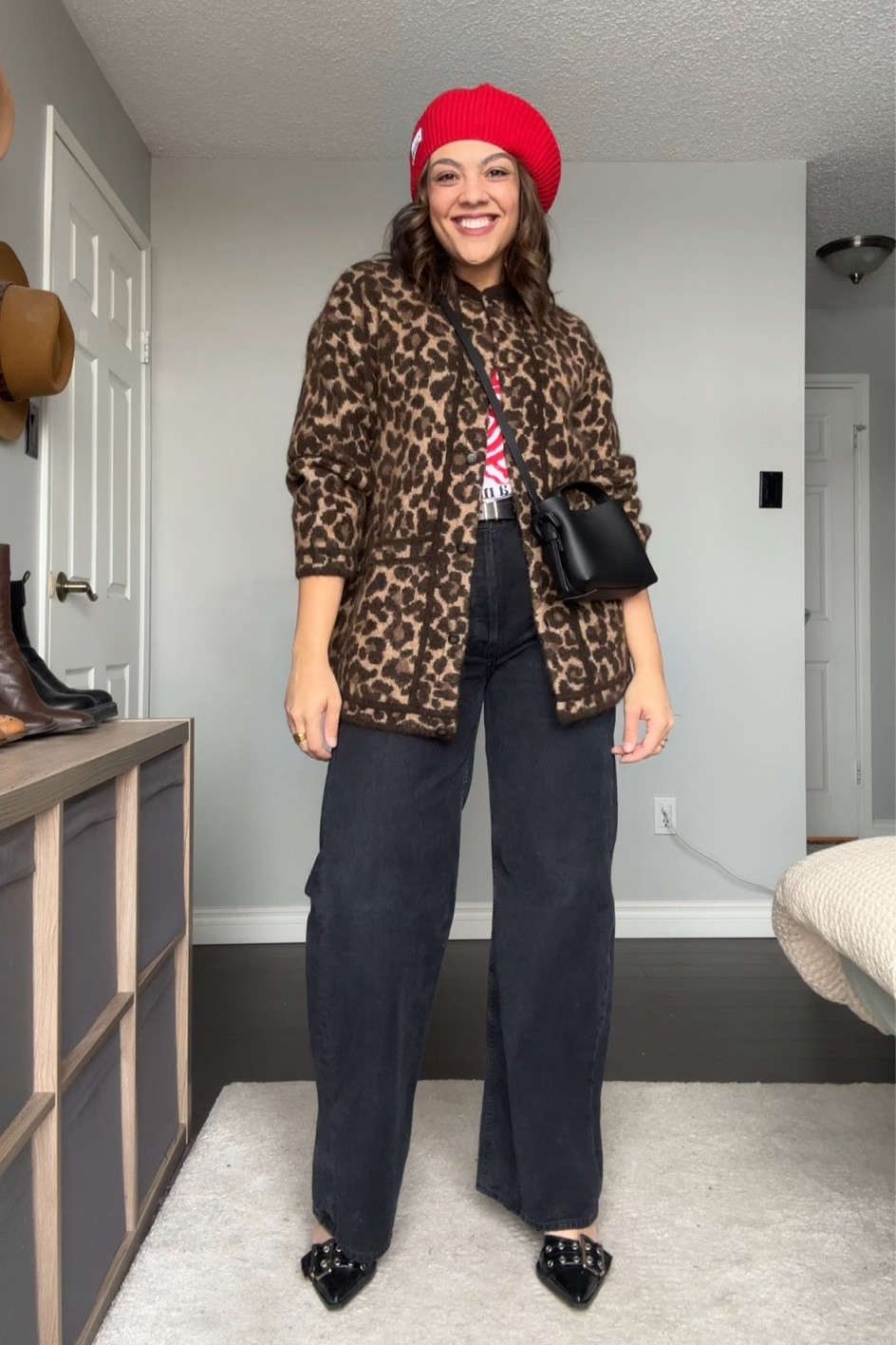 Tips for styling wide leg jeans and a cardigan!
1. Add some colour and patterns to complement the outfit. 
2. Wear a heel to elongate your legs. 
3. Accessorize! Add things like a hat, belt, and bag to add detail and dimension. 

-Sézane leopard print lint cardigan. I have a medium. 
-Ganni red print graphic tee. I have a medium. Similar option linked. 
-Citizens of Humanity black wide leg baggy jeans. I have a size 29. 
-Black belt with gold buckle. 
-Arket black mini crossbody bag. Similar linked also. 
-Ganni red beret. 
-Ganni heeled patent leather bucked pumps. 


#LTKMostLoved #LTKstyletip #LTKSeasonal