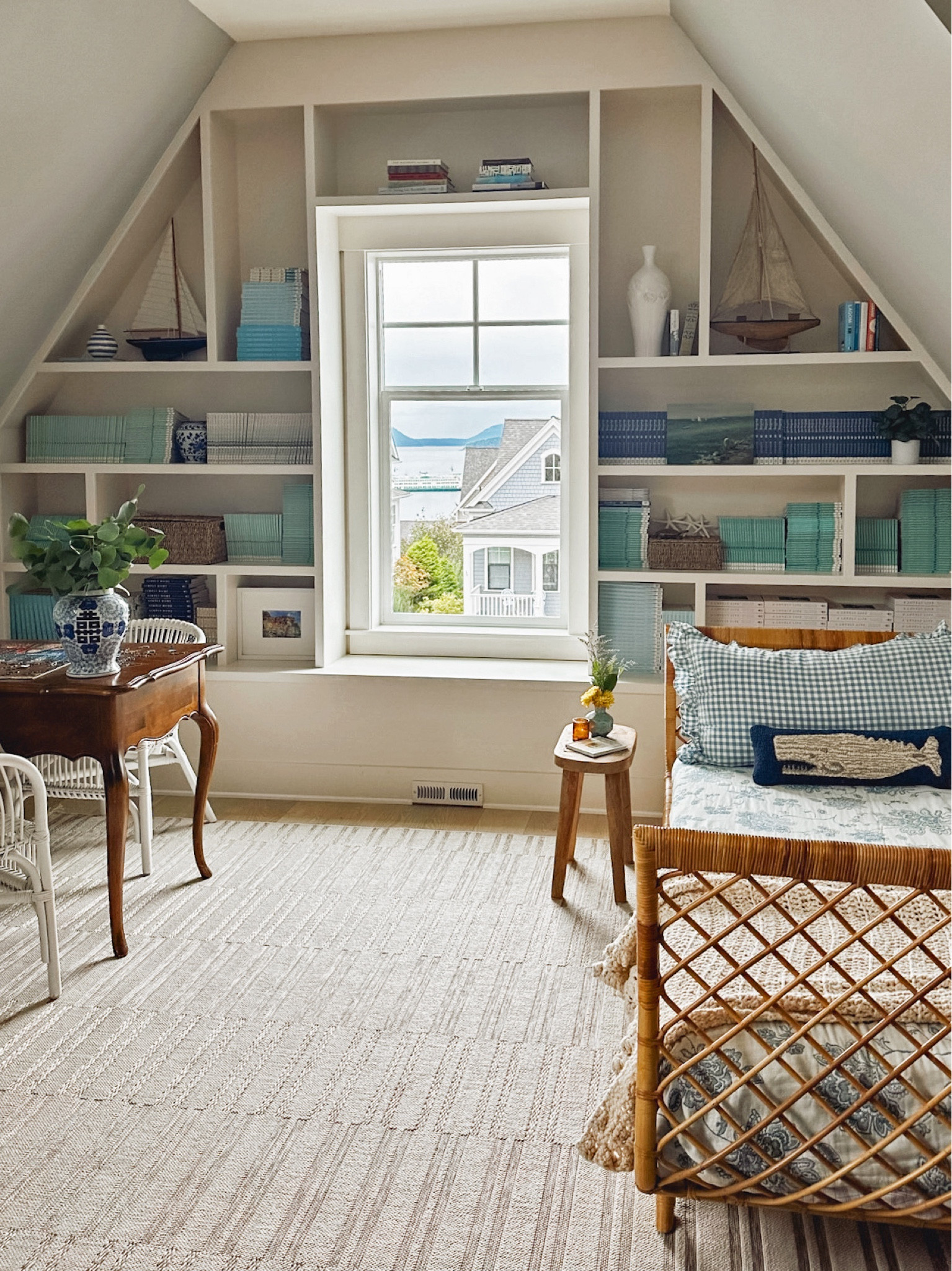 Rattan daybed, striped indoor outdoor rug, small lidded basket, wicker trunk, similar whale pillow, gingham blue ruffle pillow sham, similar wood stool and sailboats

#LTKstyletip #LTKSeasonal #LTKhome