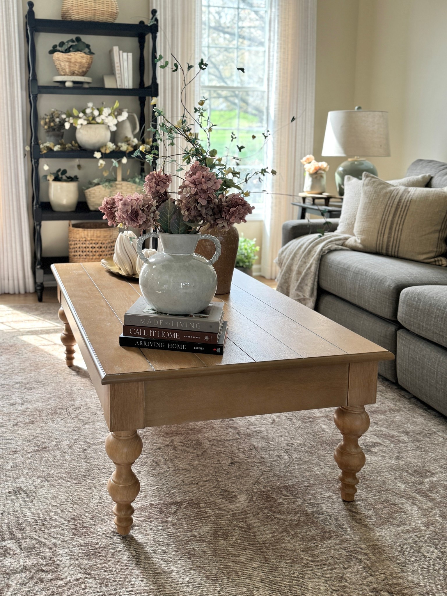 Living room styling! Coffee table, area rug, vase and florals, black open shelf, throw pillows, coffee table books, custom linen curtains, wood riser and more  

#LTKHome