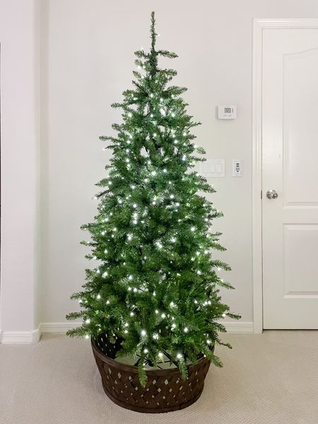 6.5 ft Yorkshire fir prelit slim tree from King of Christmas! This tree is a great affordable tree for the quality! It comes easy to assemble with a bag for storage. The lights automatically connect when it’s connected together in the stand. It also has a remote!

We flipped this tree collar from Hearth and Hand at Target to make it look like a basket!

#LTKhome #LTKHoliday #LTKSeasonal