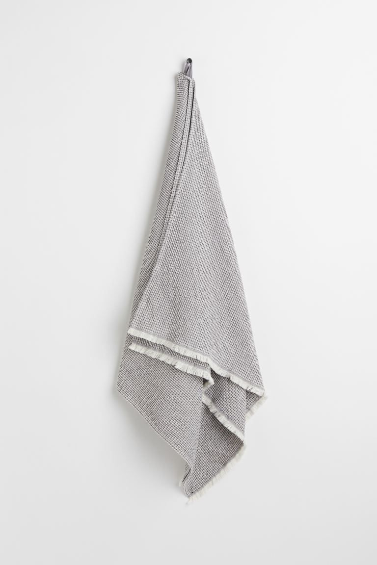 Conscious choice  Bath towel in waffled cotton fabric. Fringe at short sides and hanger loop on o... | H&M (US + CA)