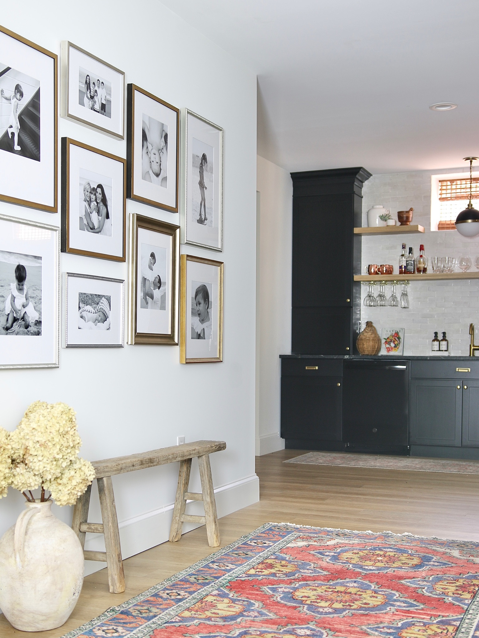 Staggered grid gallery frames, ceramic vase, wood bench, vintage rug

#LTKstyletip #LTKFind #LTKhome