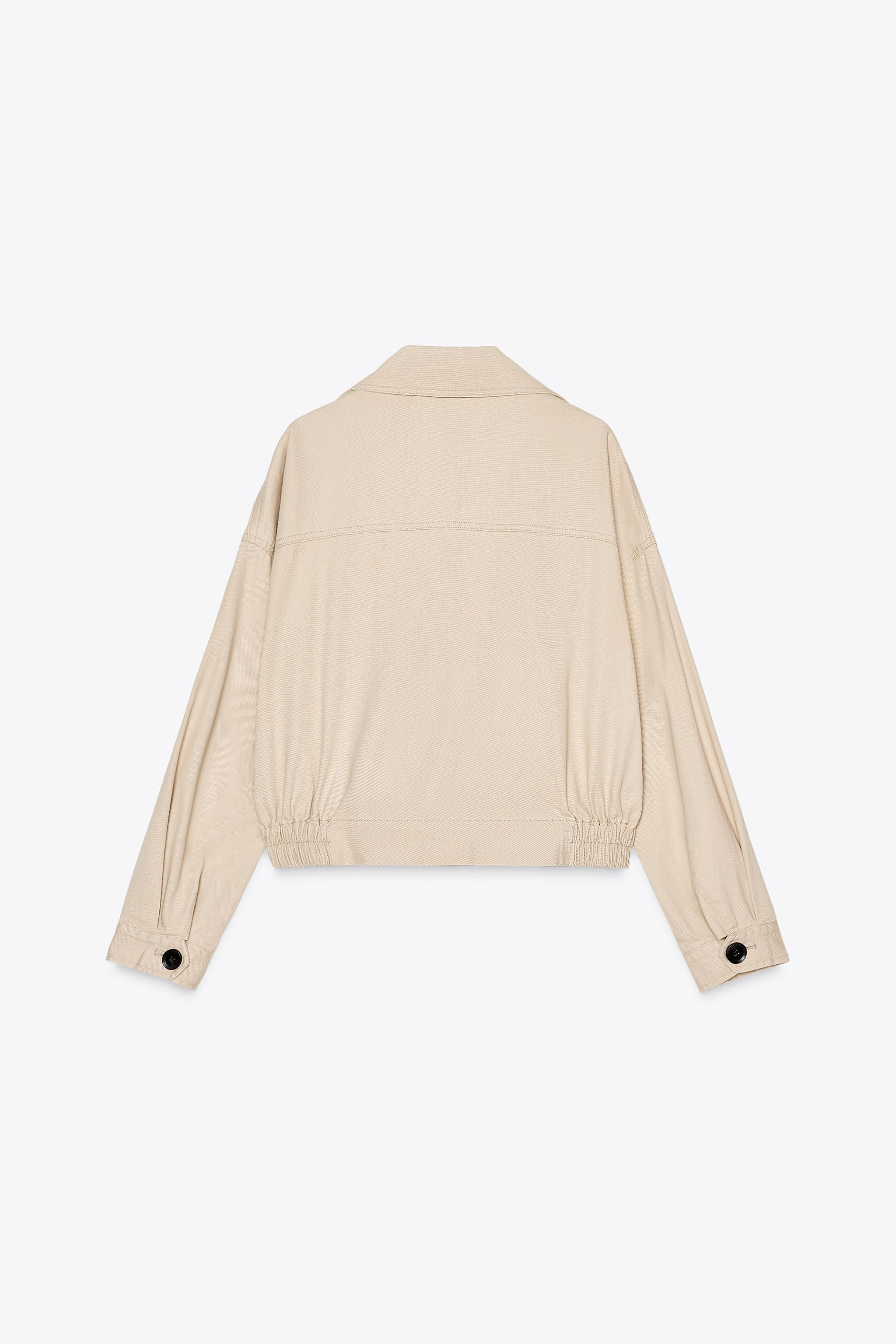 Short trench-style jacket with lapel collar and long sleeves. Front welt pockets. Hem with elasti... | Zara US