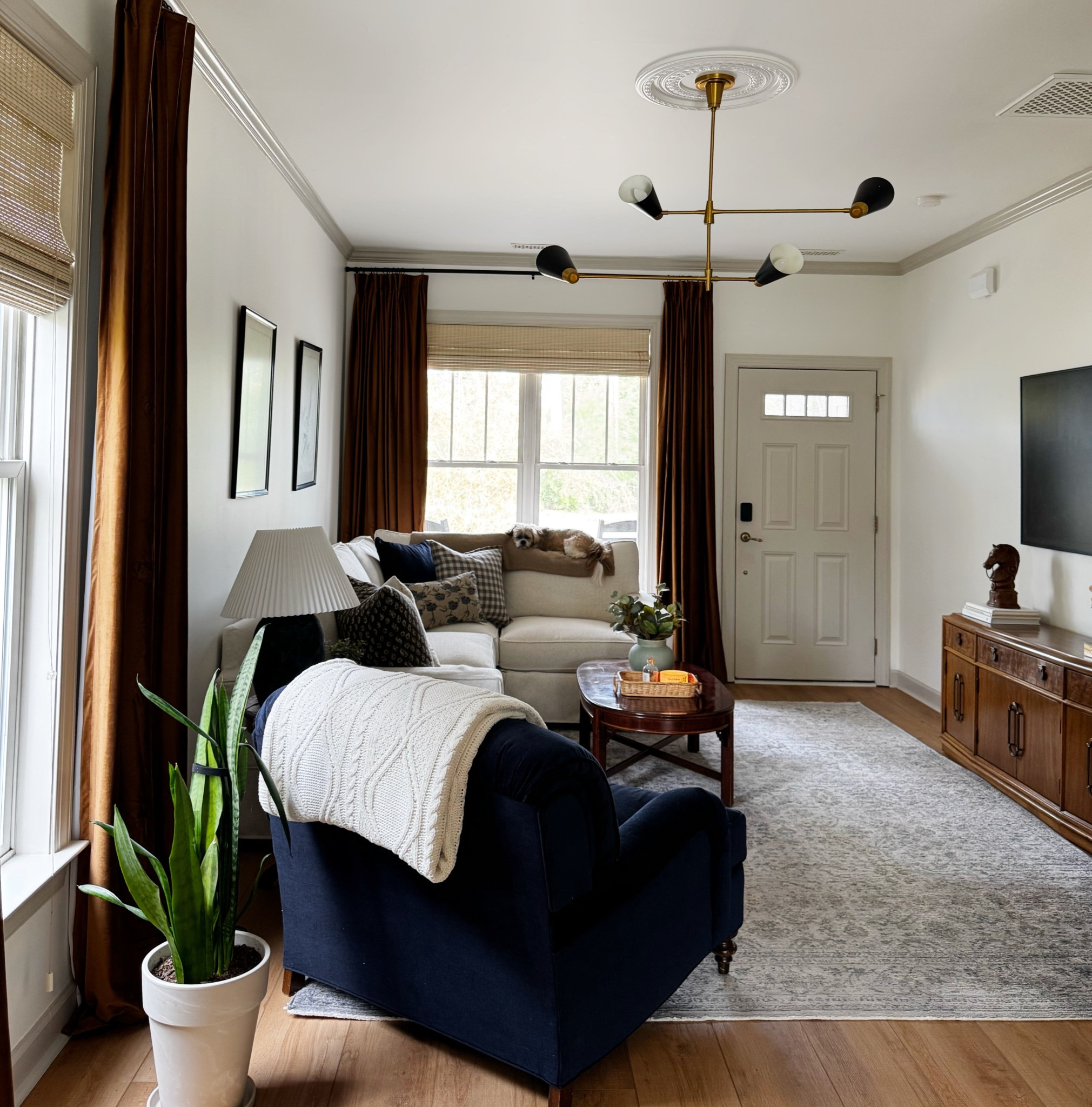 Neutral living room with bold accents / velvet curtains / navy accent chair 

#LTKHome