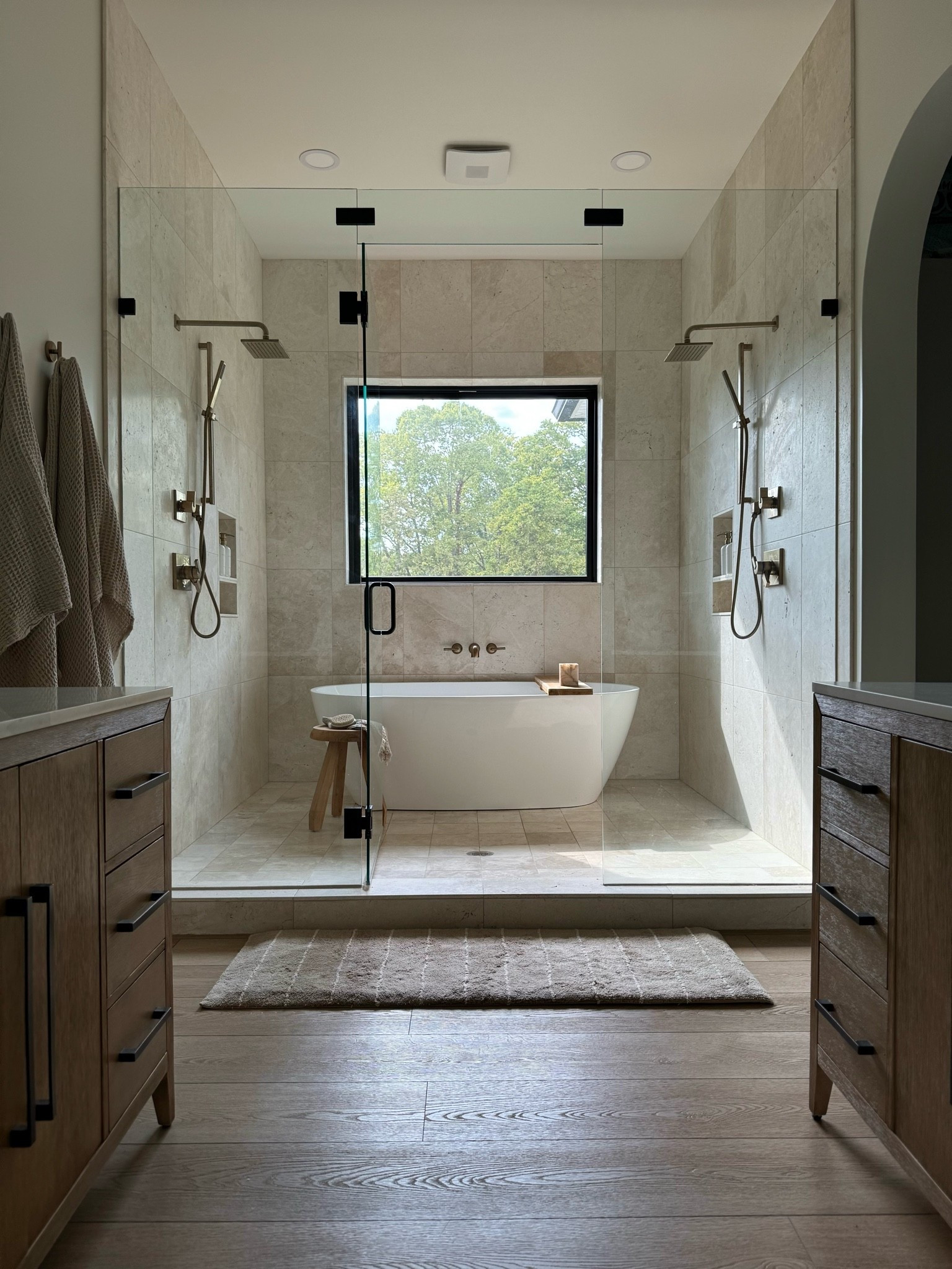 My favorite space I designed in our home– the primary bath. It’s simple yet has a spa like feel with the soft organic elements and warm wood tones 🛁🤎✨

Shower tile: Terra Nuova Brushed Marble from Floor & Decor