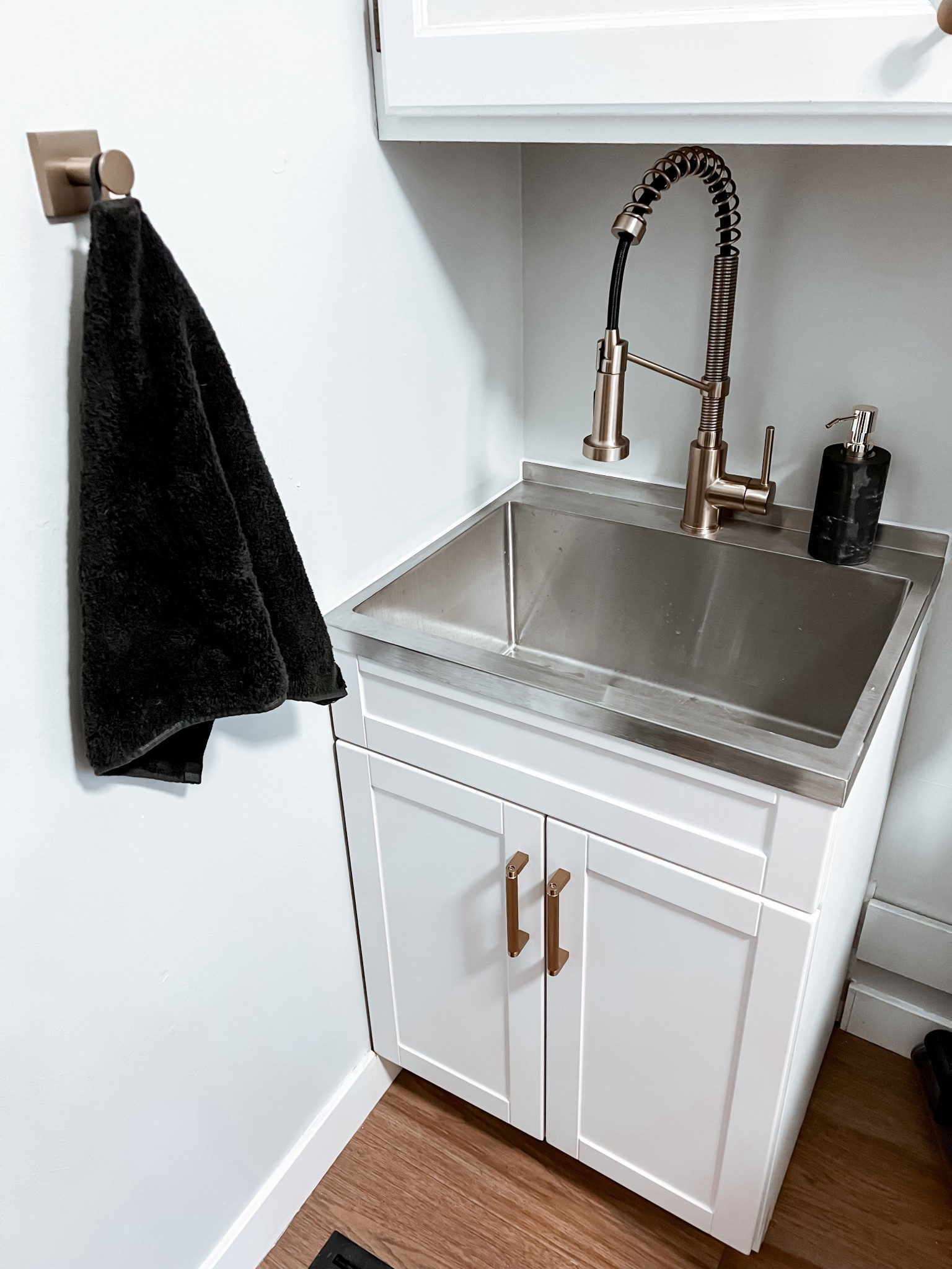 Laundry room sink with accessories! Stainless steel basin and swapped out the faucet for a brushed gold. Love the mixed metal look.Swapped out the original door pulls on the sink cabinet and added ones that we used in our kitchen!






#LTKHome #LTKSaleAlert