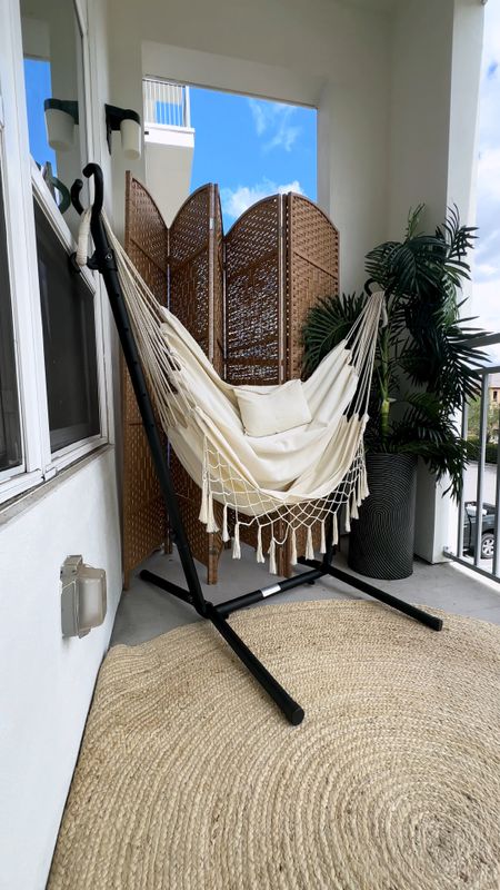 Swinging boho hammock chair for apartment balcony with faux palm tree plant and rattan room divider for cozy boho chic balcony decor
#LTKhome #LTKSeasonal
