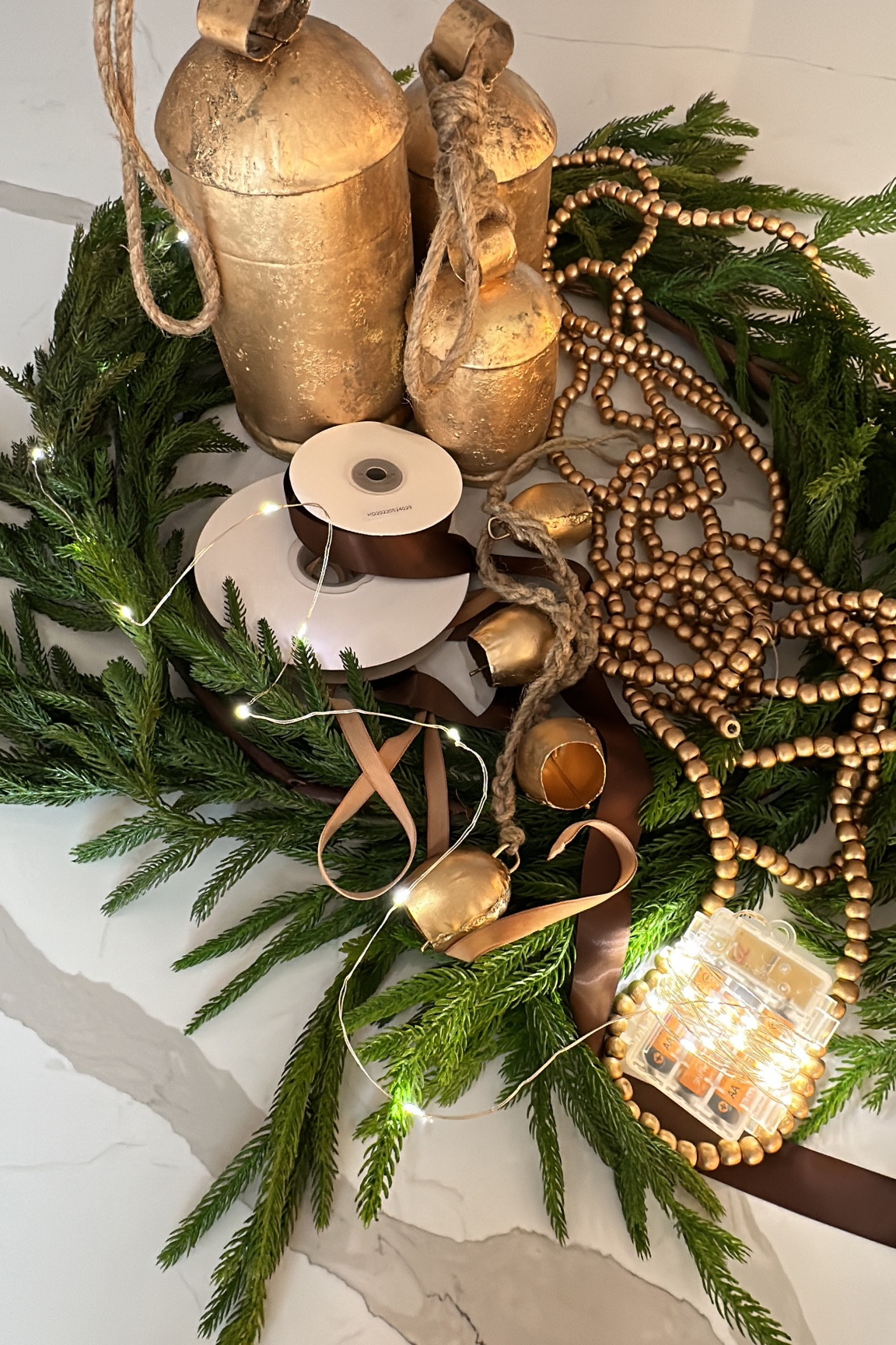 Christmas decor, holiday decor, Norfolk pine garland, realistic garland, rustic brass bells, gold bells, gold bead garland, wood garland, satin ribbon, velvet ribbon, fairy lights, twinkle lights, Christmas lights

#LTKhome #LTKHoliday