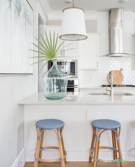 Obsessed with these new blue woven counter stools, drum pendant lights, wood serving board and large demijohn vase with a palm branch that we added to our vacation rental, Hola Beaches 30A! 

beach rental decor, coastal decor, coastal design, coastal style, decorating ideas, kitchen decor, coastal kitchen, serena and lily kitchen, pb inspired, simple home decor

#LTKunder50 #LTKunder100

#LTKSeasonal #LTKsalealert #LTKhome
