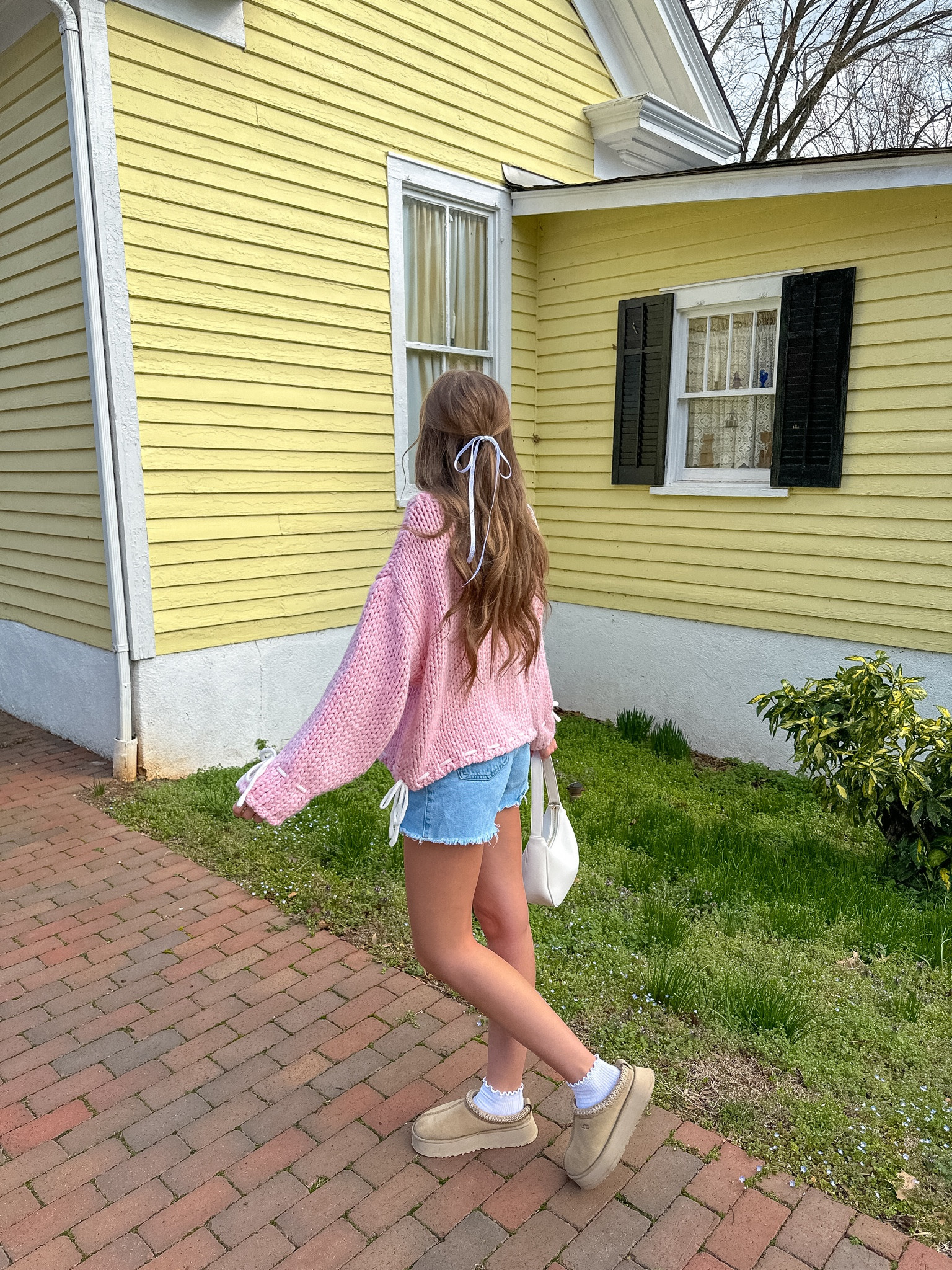 girly spring outfit with bows 🎀

pink sweater, bow sweater, denim shorts, platform UGGs 