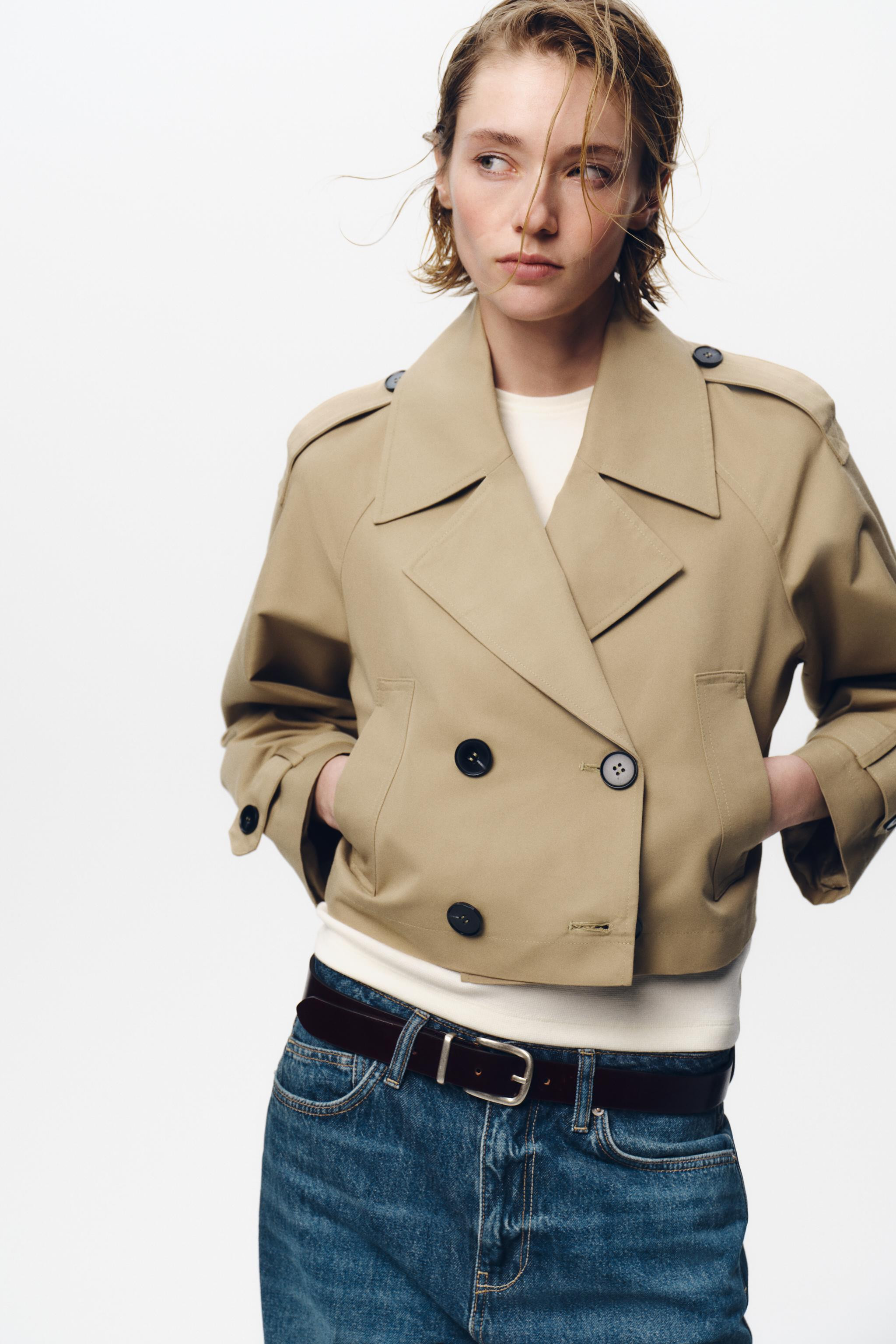 Short trench-style jacket with lapel collar and long sleeves with tab and button cuffs. Front wel... | Zara US