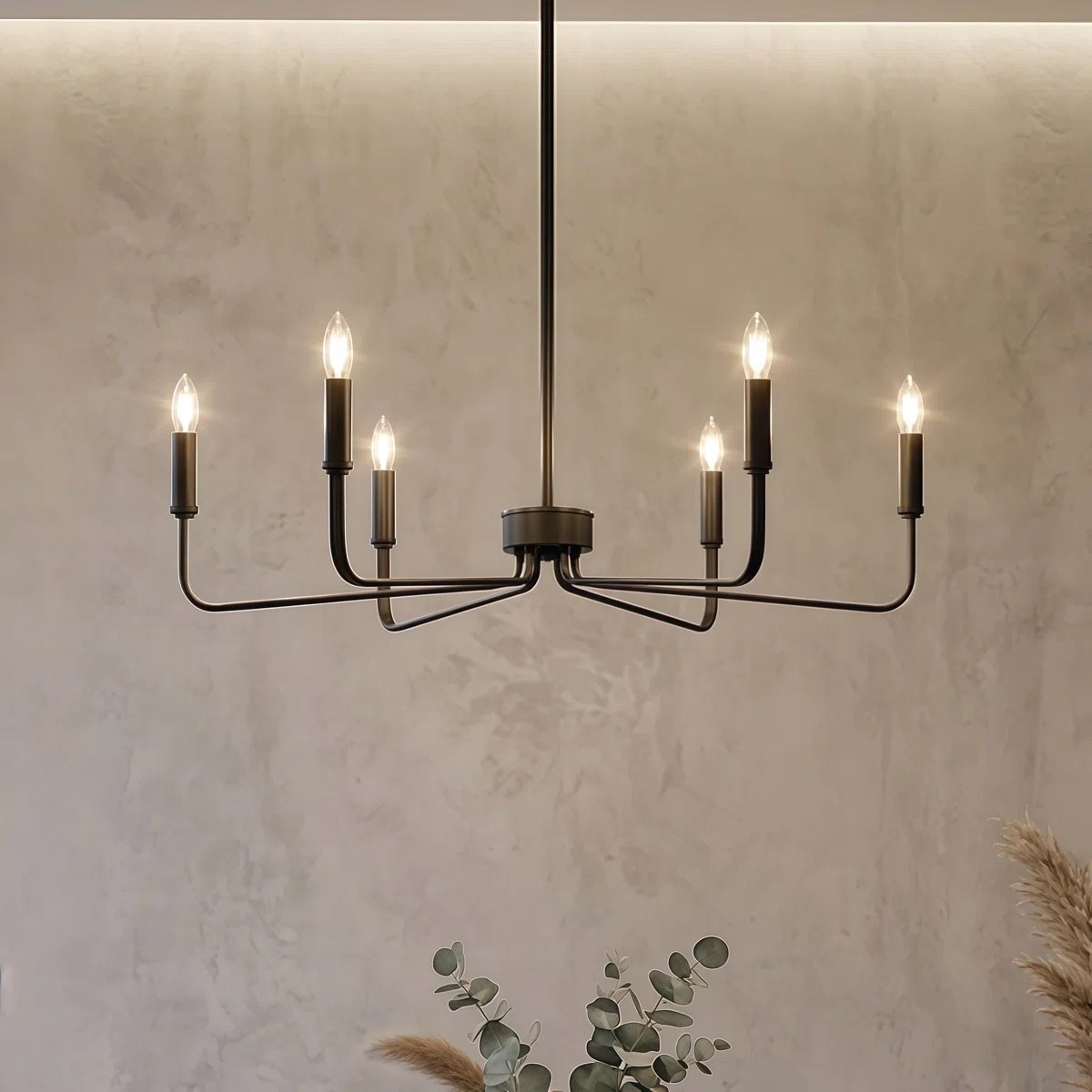 This 6 light candle style chandelier by Winston Porter is such a timeless statement piece for a kitchen or dining space. The black finish and classic silhouette give it that modern traditional look that works with everything from farmhouse to transitional decor. Perfect over a kitchen island or dining table, styled with soft greenery and neutral tones for a warm, inviting glow. 