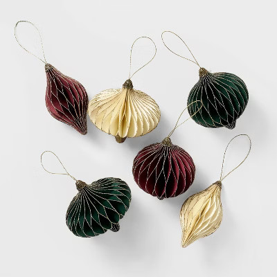 Six honeycomb paper ornaments in burgundy, green and cream