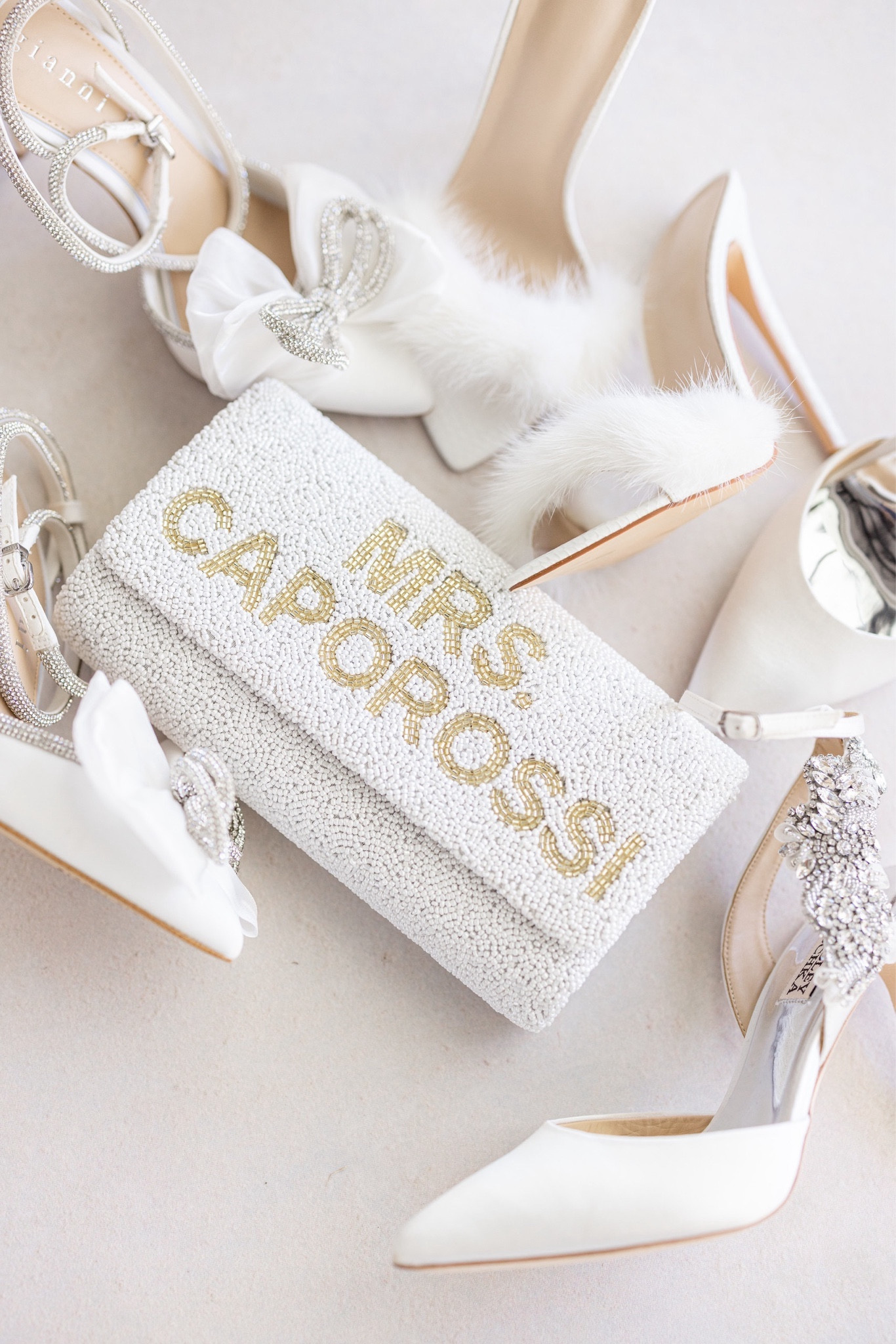 Wedding Shoes + Bridal Accessories ✨

This bridal purse is the perfect detail for your wedding day! I received it as an engagement gift at my bridal shower. I was excited to use it during my bachelorette party! On my wedding day, it was big enough to keep all the essentials safe. It is completely customizable! You can personalize the purse with your new last name or initials. You can choose silver or gold beading. You can also choose a silver or gold chain, so the bridal bag can be used as a clutch or worn as a crossbody. You can even have you wedding date displayed on the inside of the bag with intricate beadwork! 

Wedding bag, wedding purse, wedding clutch, bridal bag, bridal purse, bridal clutch, personalized purse, custom purse, wedding gift, bridal shower gift, engagement gift, wedding anniversary, bachelorette party purse, bachelorette party outfit, engagement party, engagement pictures, engagement party outfit, elopement, elopement outfit, bridal outfit, wedding reception, rehearsal dinner, bridal shower outfit, honeymoon, honeymoon outfit, beaded bag, beaded purse, white purse, bride gift, bridal gift, custom gift, rehearsal dinner outfit, bridal outfit, bride outfit, wedding shoes, bride shoes, bridal shoes, wedding heels, bridal heels, bride heels, white heels, white satin heels, fur heels, bow heels, white bow heels, bow trend, rhinestone heels, crystal heels, white pumps, white stilettos, ivory heels, Gianni Bini, Dilliard’s, Badgley Mishka, Steve Madden, bridal denim jacket, custom denim jacket, jean jacket, pearl jean jacket, classy heels, wedding Inspo, wedding ceremony, wedding reception outfit, wedding party 

#LTKshoecrush #LTKitbag #LTKwedding