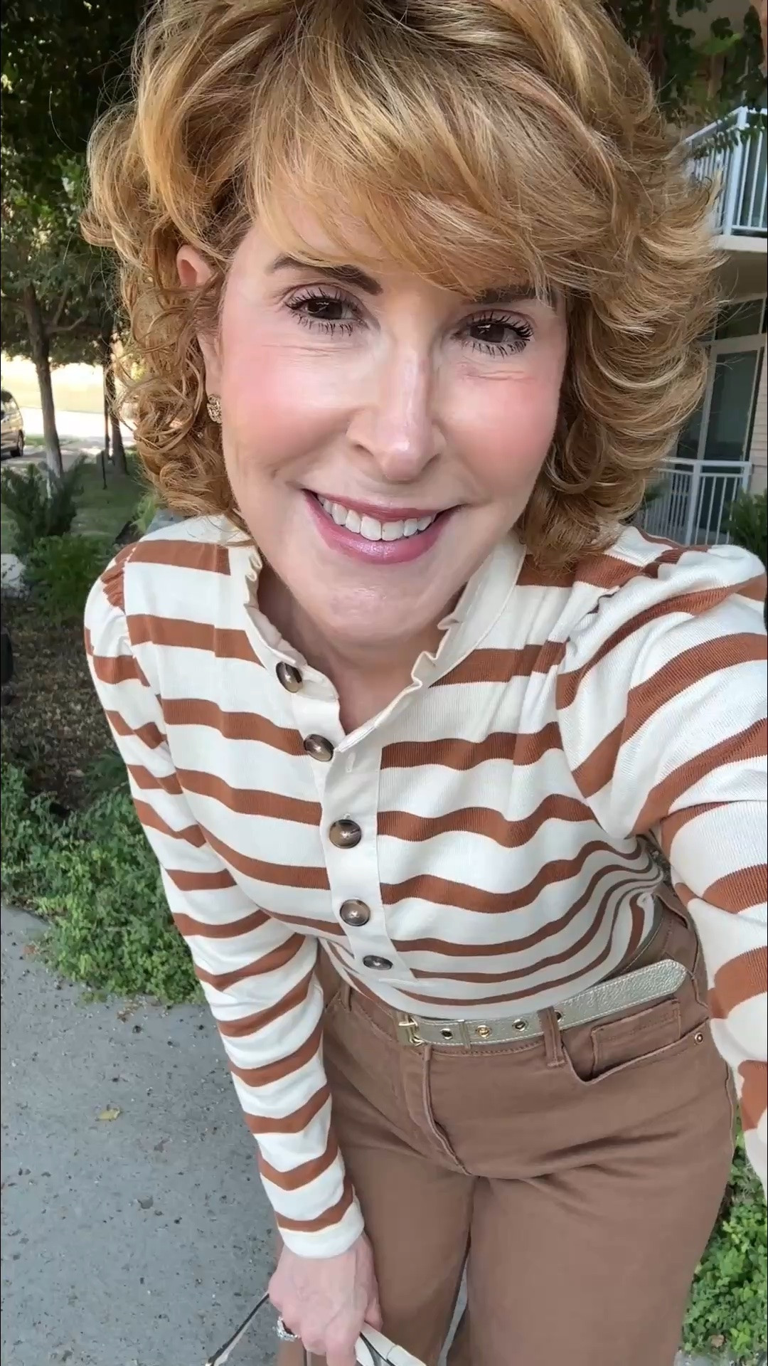 Fall fashion trends for women over 50! I’m wearing the statement collar trend with this striped pure cotton rugby shirt featuring a feminine ruffled collar and puff sleeves. I paired it with brown-wash wide-leg jeans, retro lace-trim sneakers, a gold metallic leather belt, Gucci GG Marmont camera bag, and Gucci Double G crystal stud earrings. I love the mix of sporty and feminine style, and the brown denim is a fresh alternative to traditional blue jeans for fall. Shop this casual fall outfit, statement collar shirt, wide-leg denim, fall sneakers, designer handbag, belt, and jewelry!

#LTKootd #LTKOver40 #LTKSeasonal