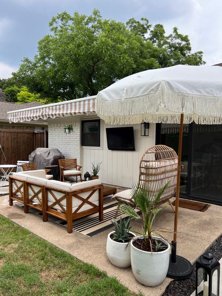 Patio refresh 🤍 summer patio ideas! We re-stained our furniture and added this amazing wicker love seat chair. 

Lanterns, plants and planters, sectional, outdoor furniture 

#LTKhome