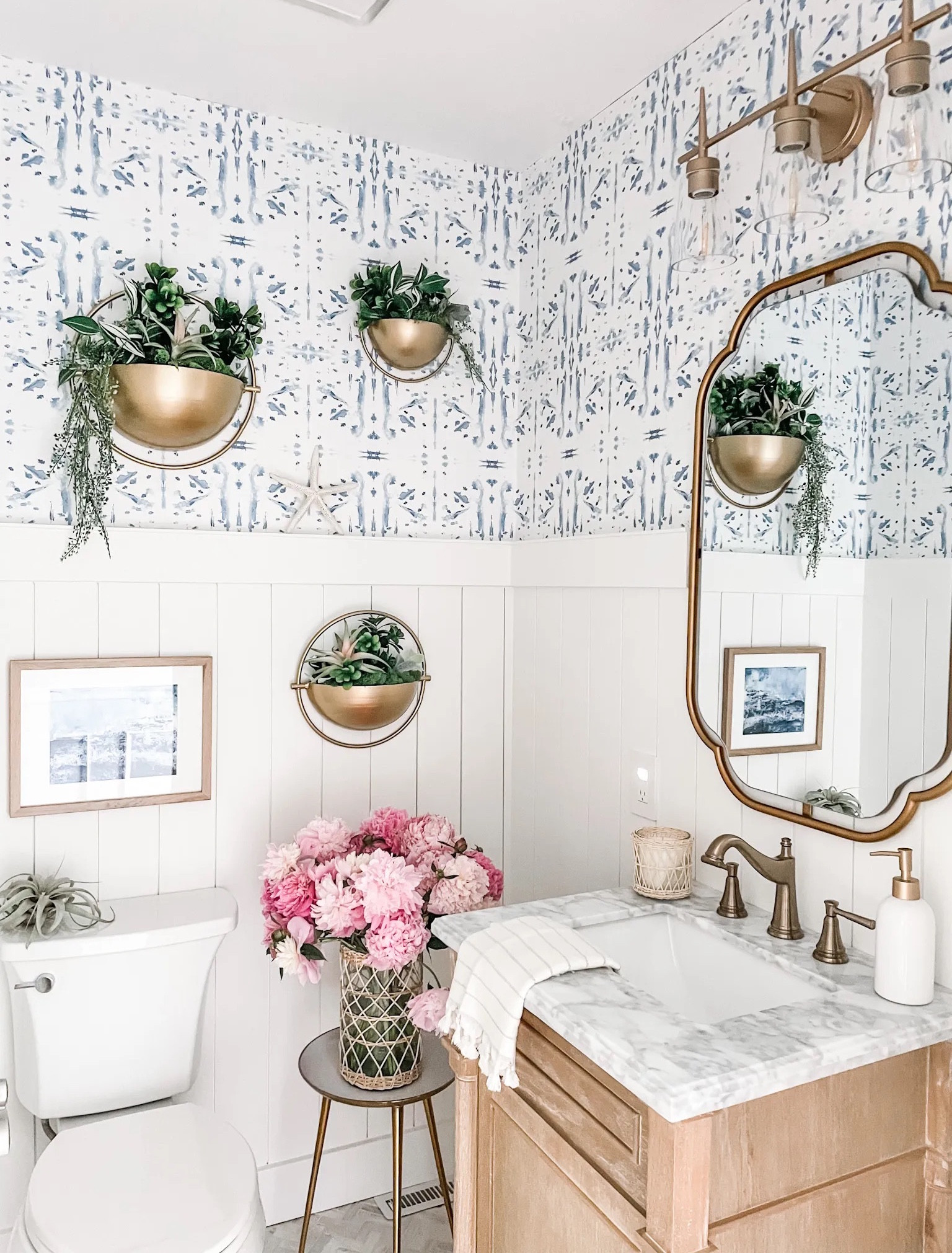 Our powder room vanity is Back in Stock! 
We remodeled this powder room last year with a coastal vibe and love this antique oak bathroom vanity with white Carrara marble top!

Powder room decor, bathroom vanity, 24” vanity, champagne bronze faucet, bathroom sink faucet, herringbone tile, wall mirror, bathroom mirror, Kolher toilet, wall art, hanging wall planter, half bathroom, Turkish hand towel, natural wood thin gallery frame, woven rattan vase, three legged table, white bath rug, woven trash can, waste basket, white ceramic soap dispenser.

#powderroom #bathroom #vanity

#LTKhome #LTKFind #LTKstyletip