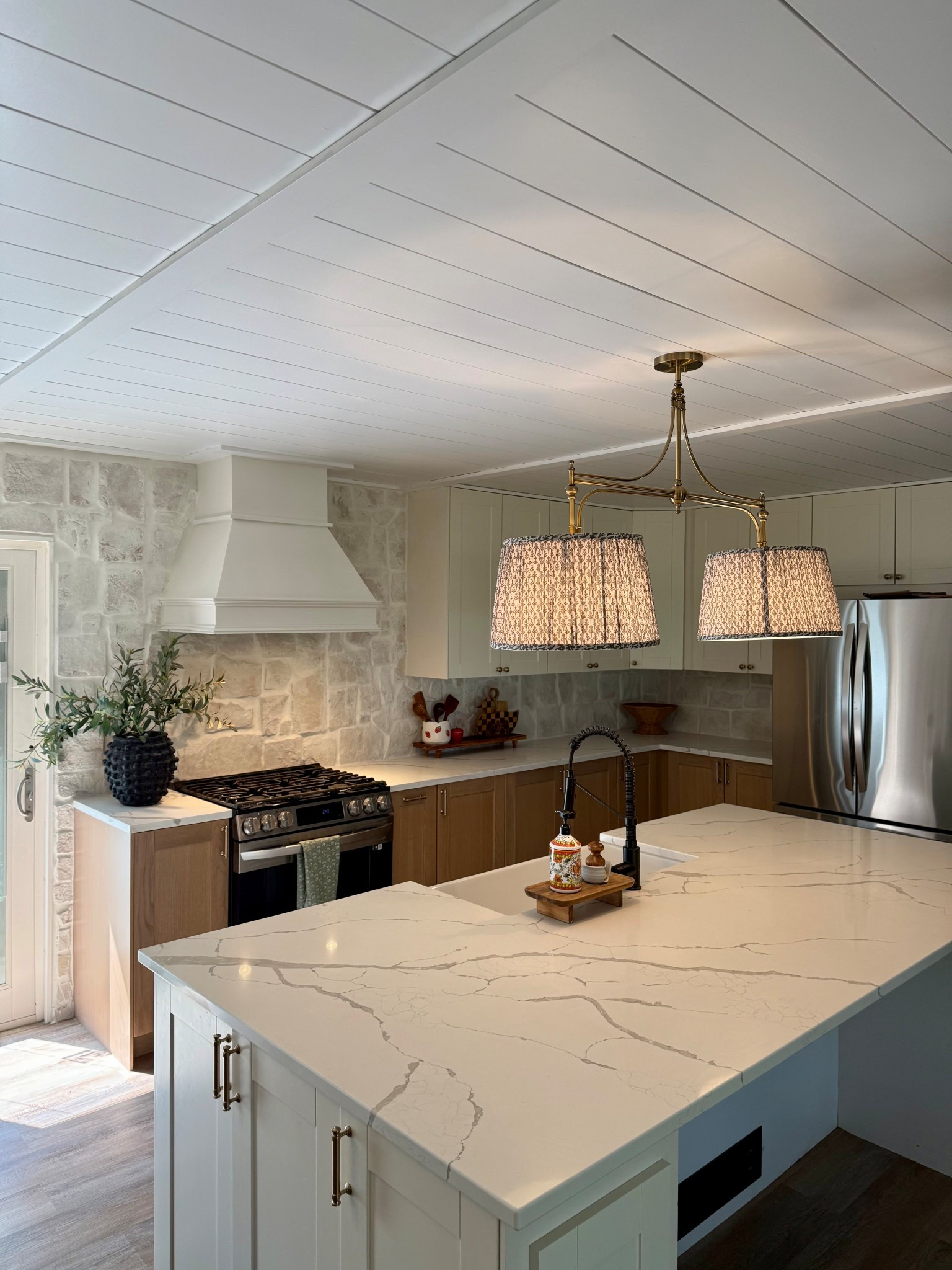 Top questions in my inbox include "what stone is your backsplash" + "where is your pendant light from?"

i cannot link the stone but it is from Floor and Decor and is Alamo Sandstone. I did however link the light and shades. 

#LTKHome #LTKSaleAlert #LTKStyleTip