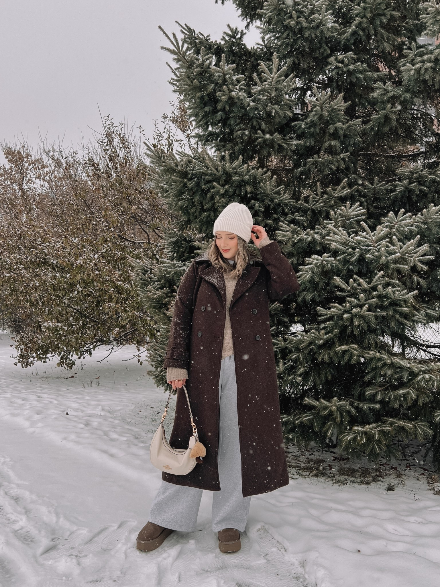 Cozy winter outfit! Wearing my usual size L in the chocolate brown wool trench coat - it’s so warm and such a good staple piece! Also wearing L in the wide leg sweatpants, these are thick and cozy and cute enough to wear out! This white tee is my fave for layering since the neck is higher, wearing my usual size L. My Ugg style boots are Amazon and such good quality! I’m usually a 9.5-10 and wear a 10 in these. Linked similar neutral sweaters & cream beanie


#LTKwinter #LTKstyletip #LTKmidsize