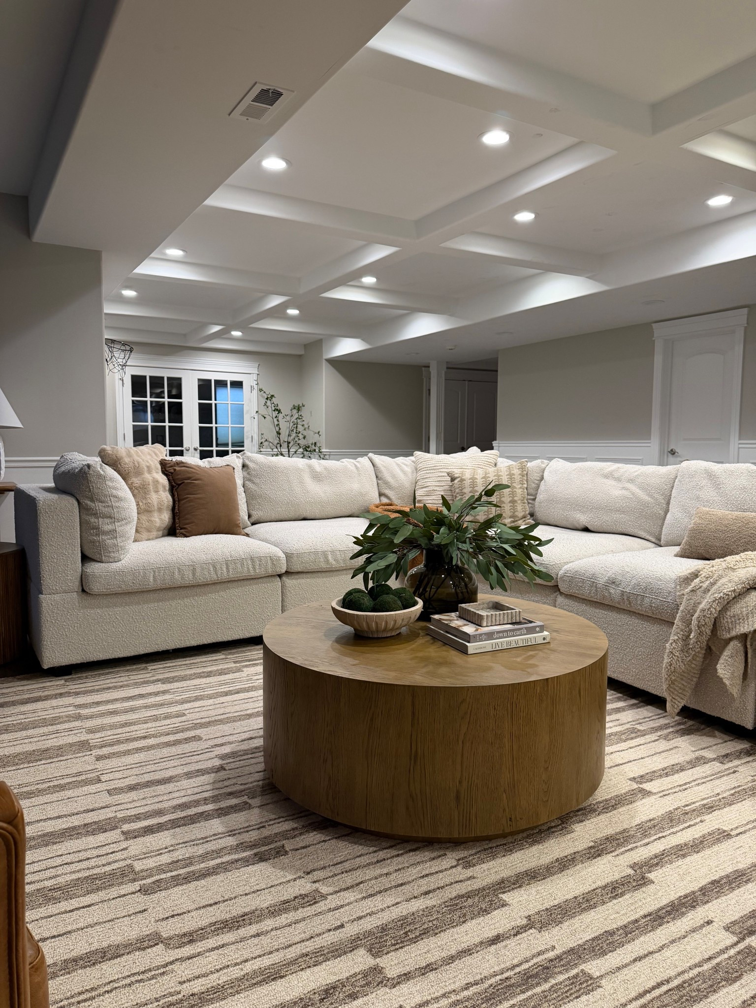 A closer look at our basement family room 🤍

This oversized sectional is one of our favorite pieces in the house — cozy, durable, and perfect for movie nights with the kids. I layered warm wood tones, texture, and neutral pillows to keep the space feeling calm and inviting.

Linking the sectional, coffee table, rug, and styling pieces here.

#LTKHome #LTKSaleAlert