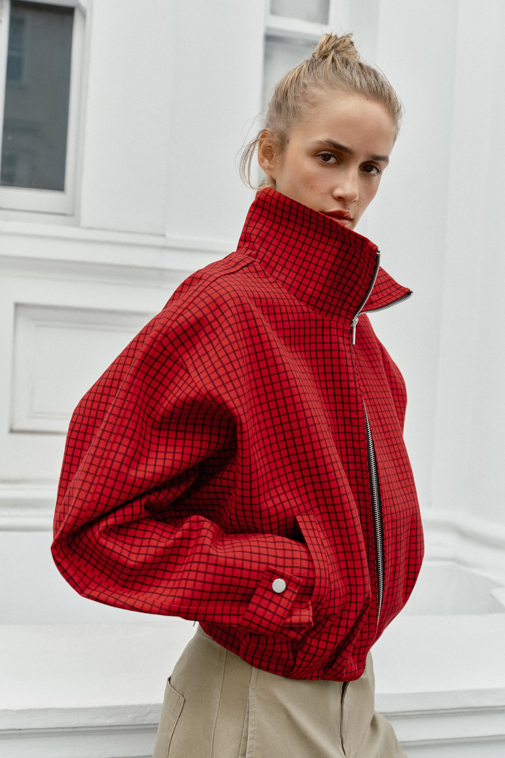 Bomber-style jacket with a high collar and long sleeves. Adjustable cuffs with snap-button tabs. ... | Zara US