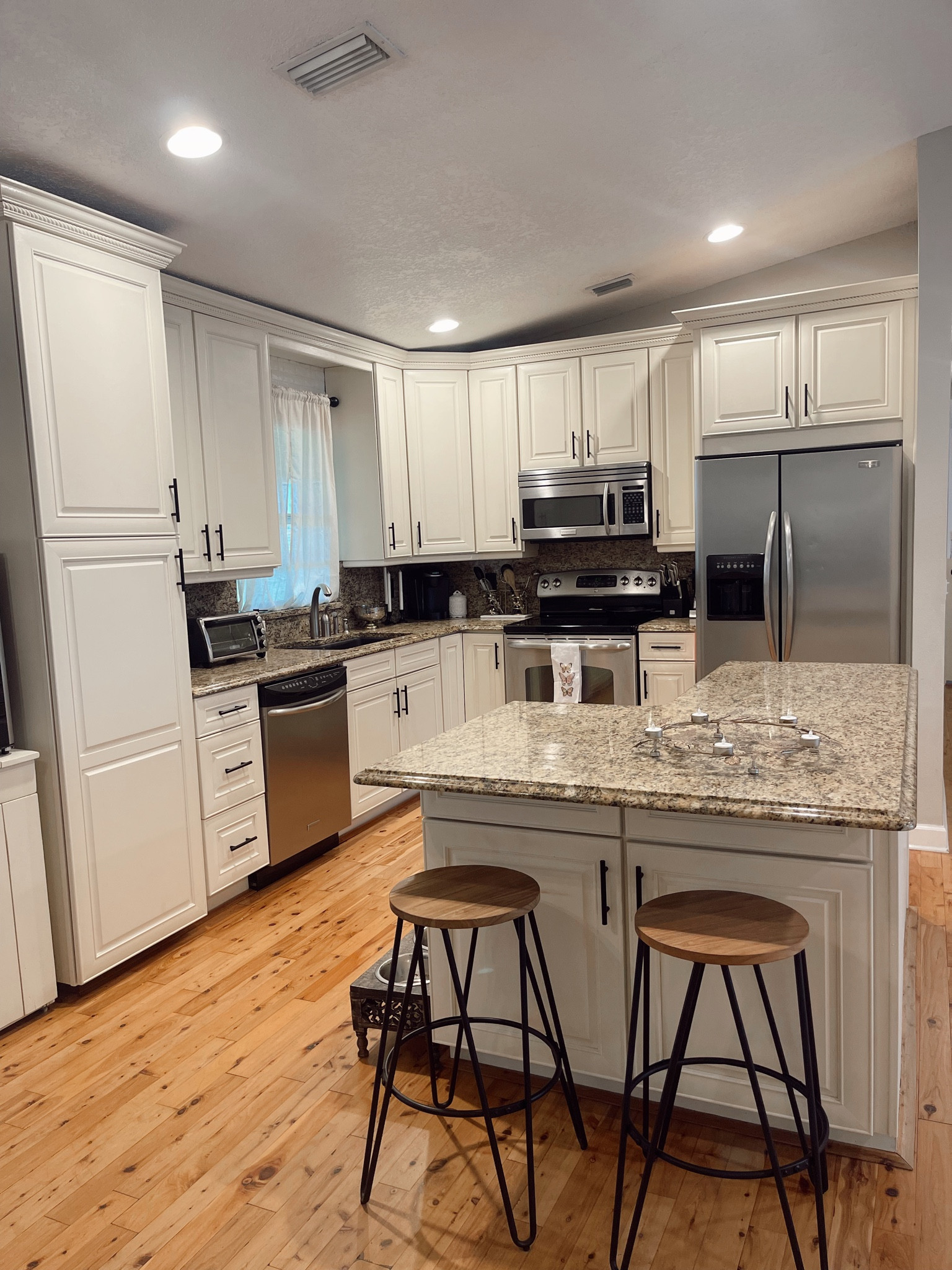 I chalk painted our kitchen cabinets and replaced the hardware with black handles from Amazon a few years ago & I couldn’t be happier with how they turned out! The paint hasn’t chipped at all; the cream/antique white color on the cabinets brightened up the room. The wood and iron barstools are also from Amazon and super affordable! 

#LTKhome #LTKfindsunder50 #LTKfindsunder100