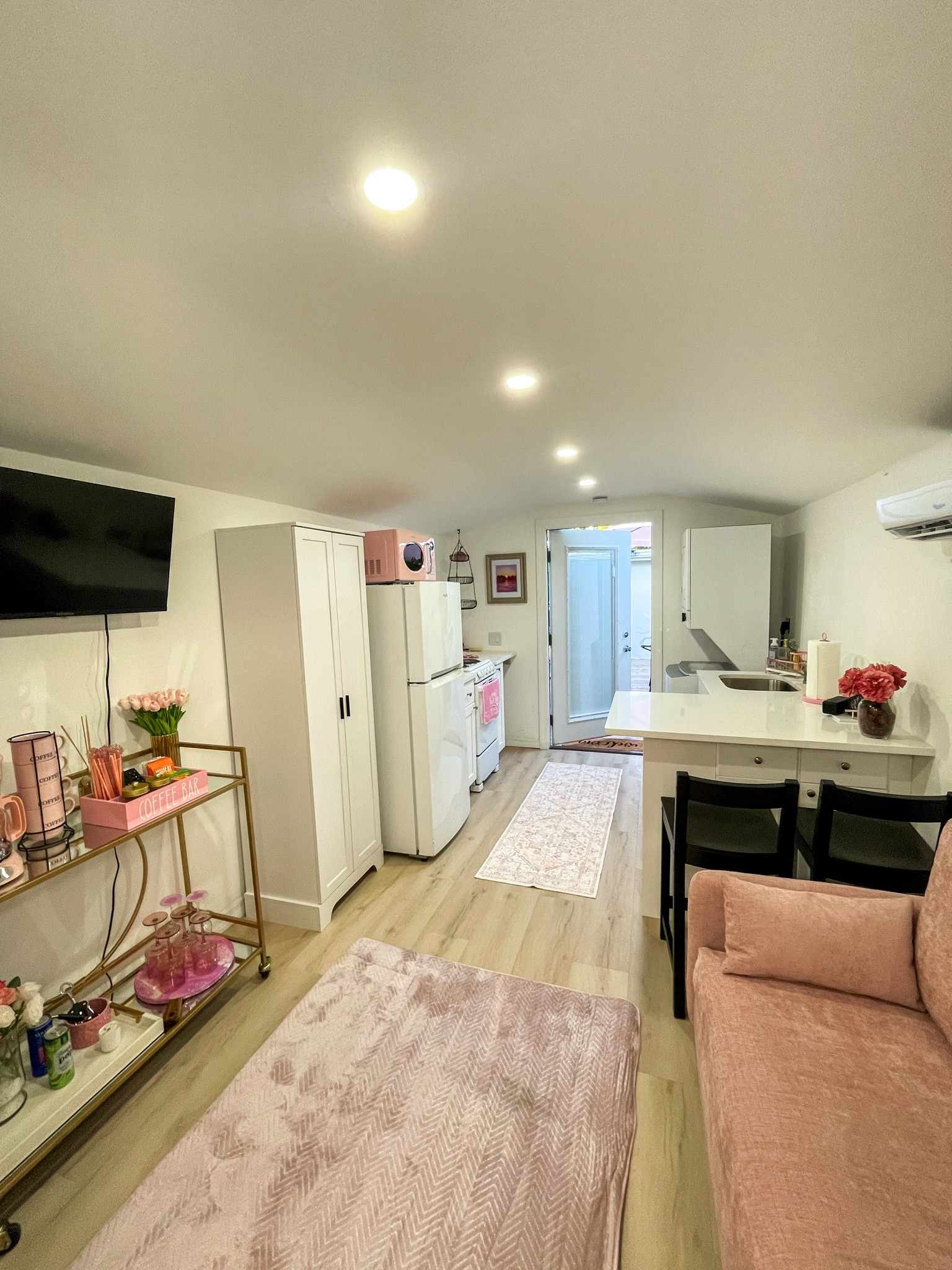 A full tiny home layout — kitchen, living space, and entry.