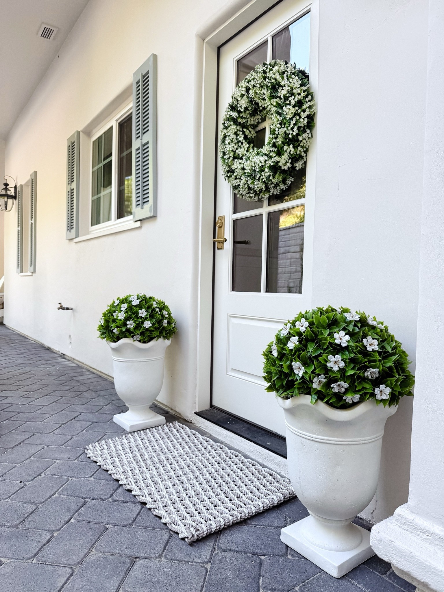 The urns I found at HomeGoods are online! Topiary was sold separately.