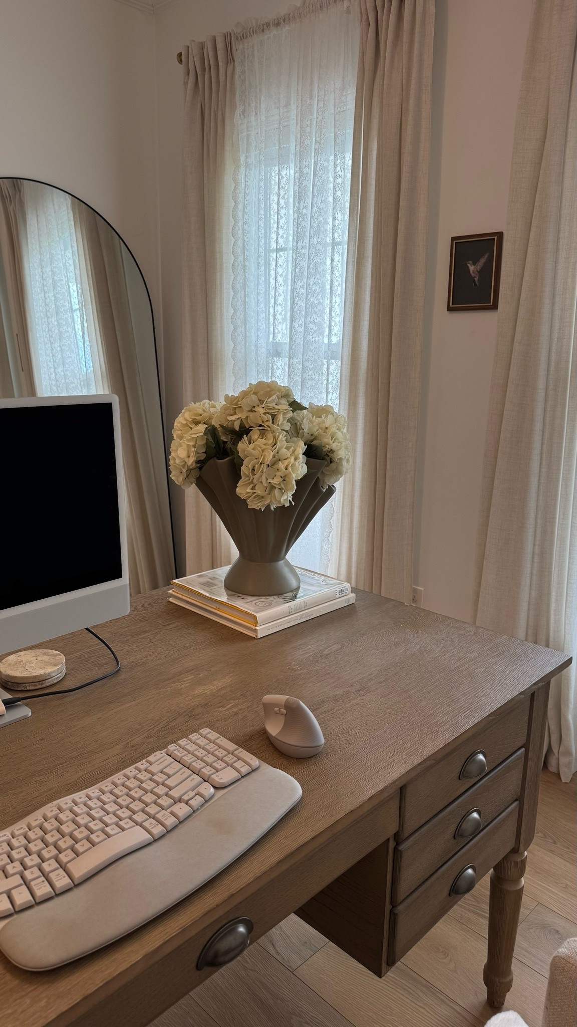 My home office - lace curtains, faux hydrangeas, big desk, arched mirror.

#LTKSeasonal #LTKHome #LTKvlog