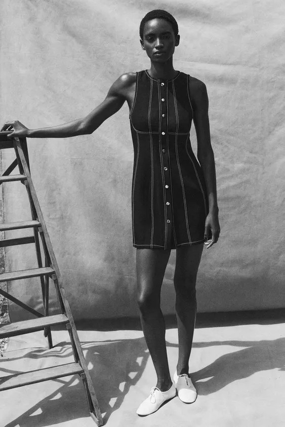 Mini dress with a round neck and sleeveless design. Features decorative front buttons and contras... | Zara US